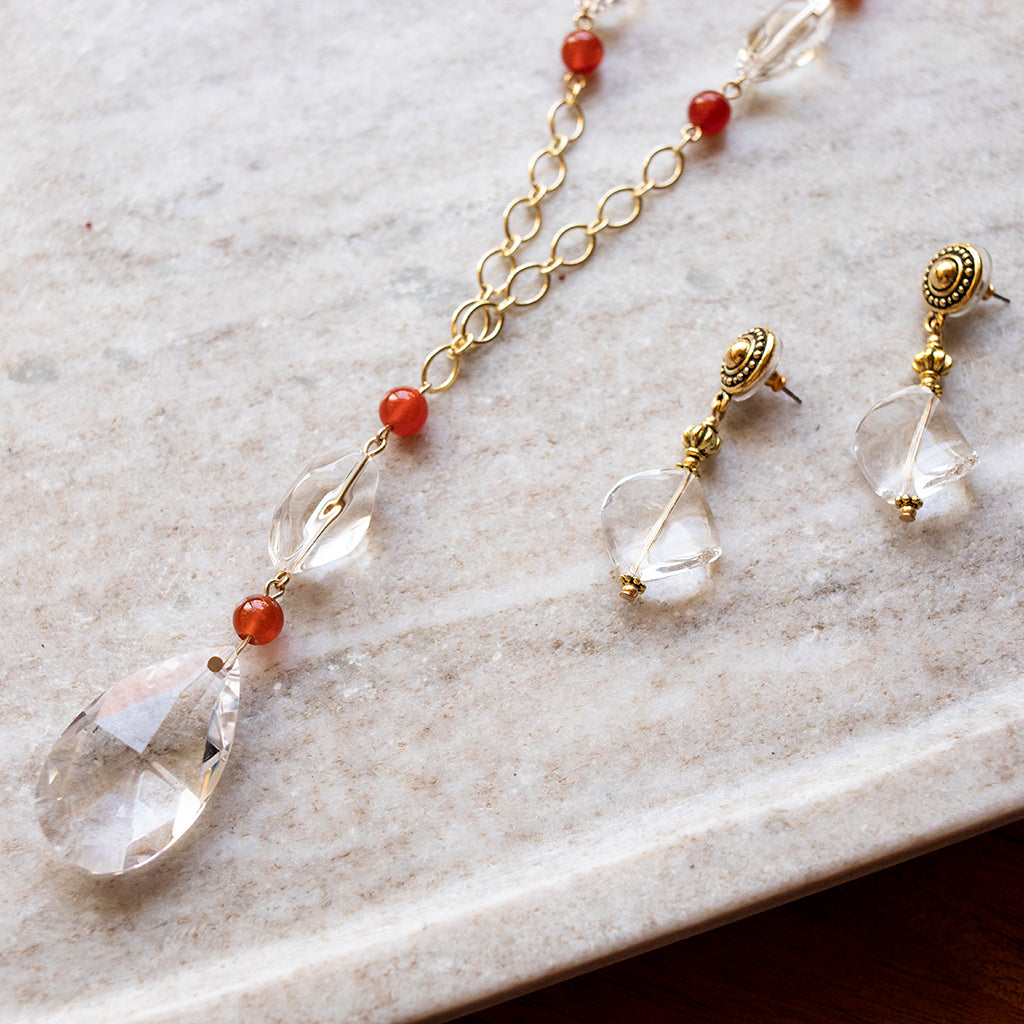 A crystal necklace and crystal pair of earrings