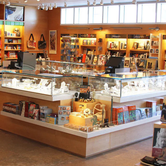 Display case with jewelry and books in a store setting