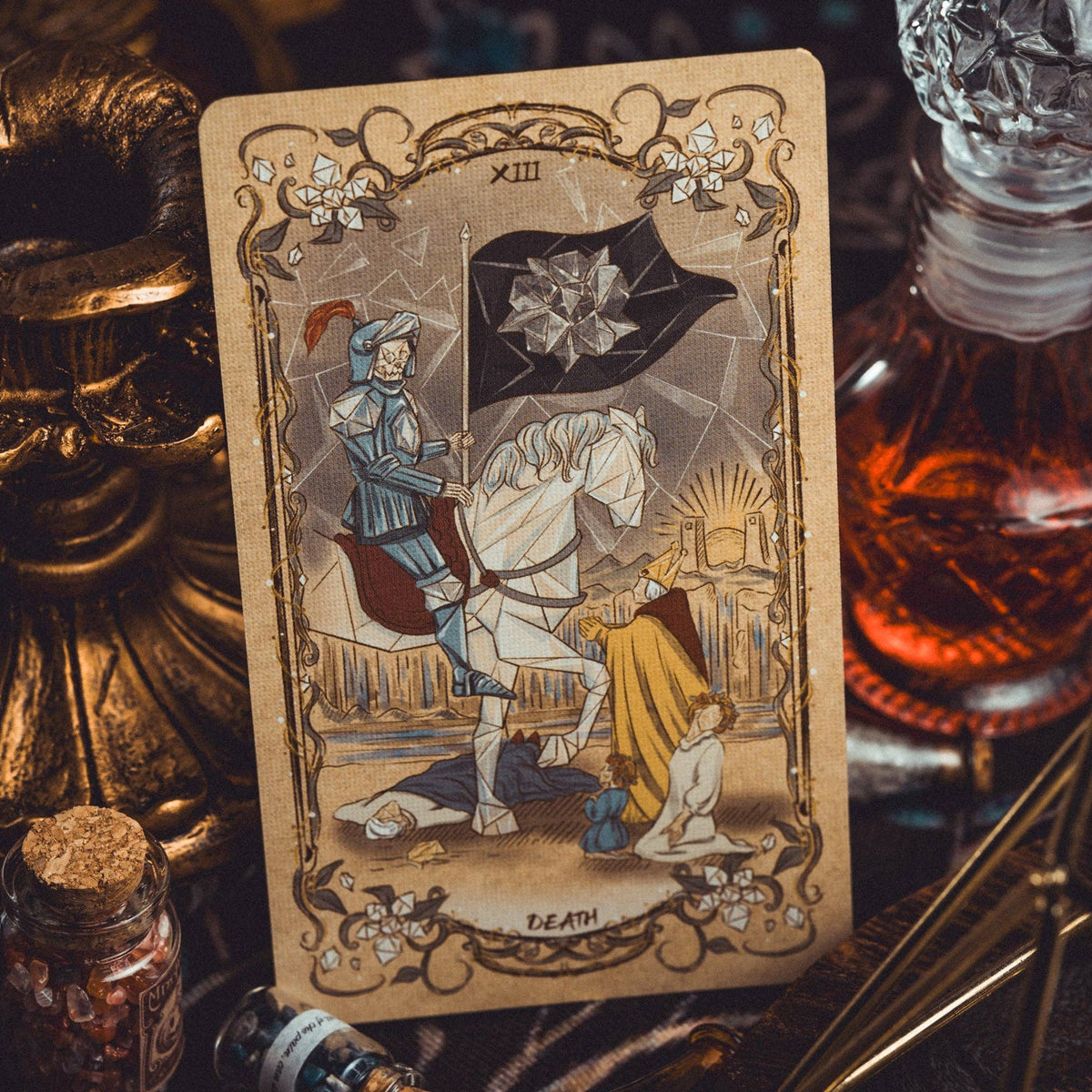 Tarot card with a rider on a horse, surrounded by decorative objects like a bottle and candle.