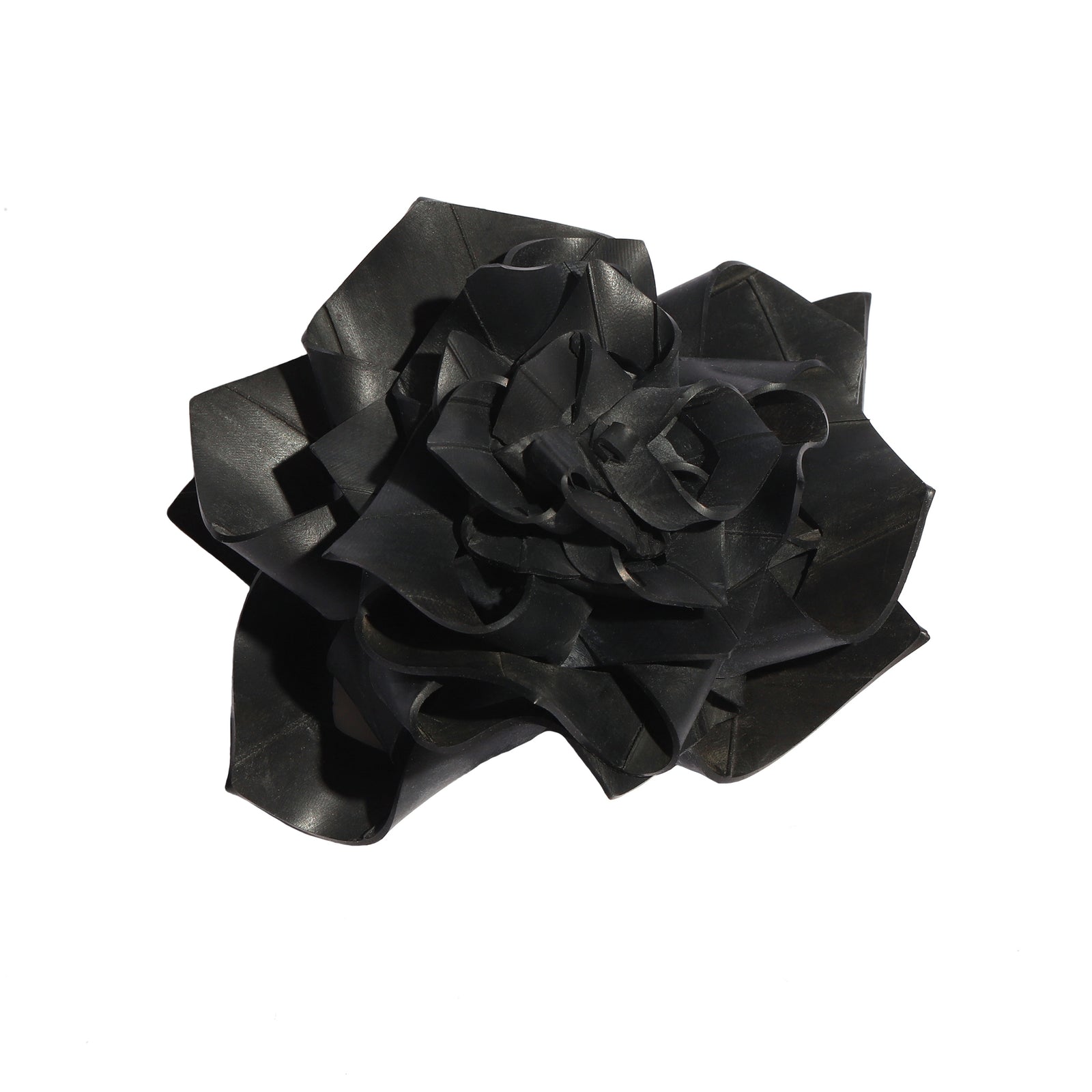 Black rubber bow brooch on a white background