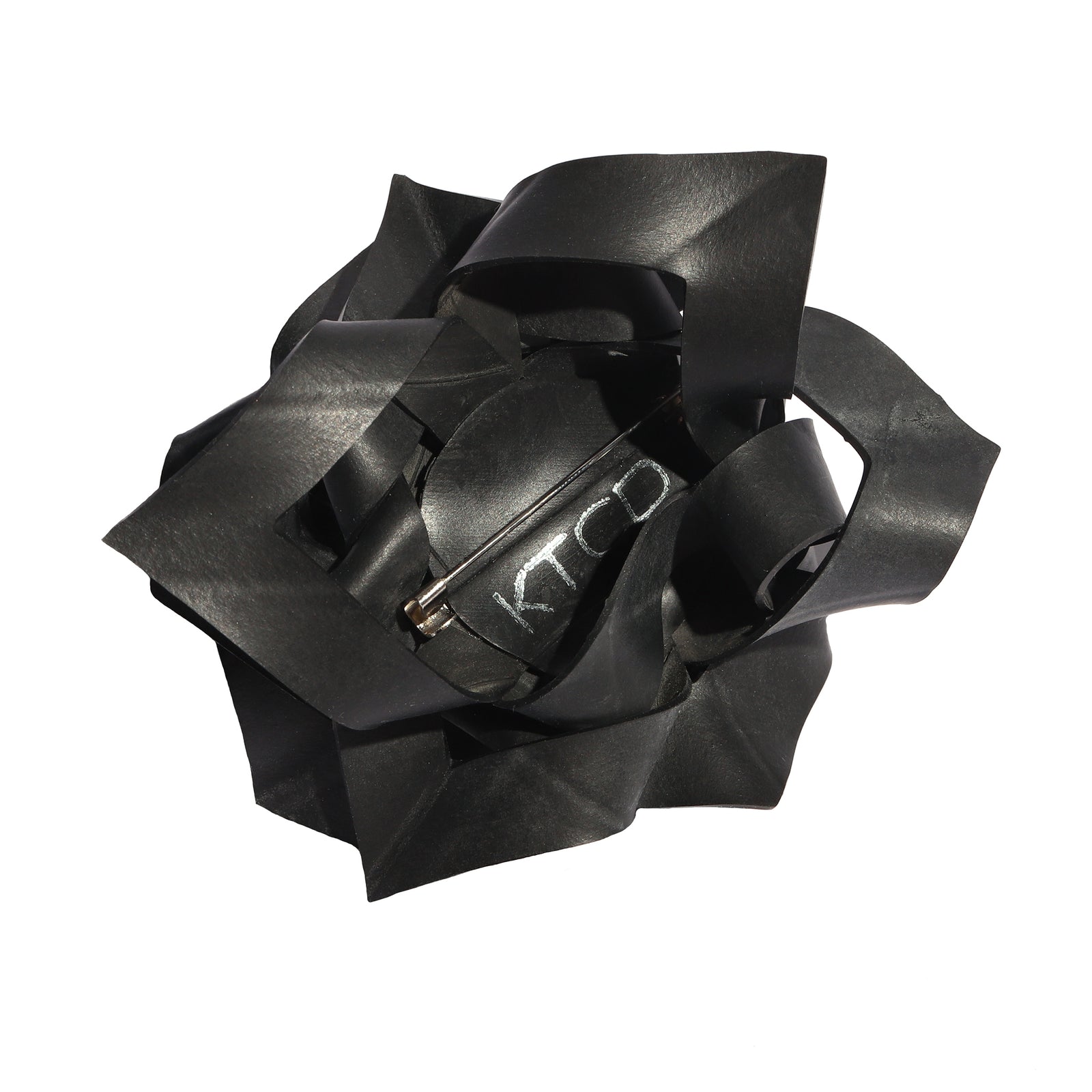 Black rubber bow brooch on a white background