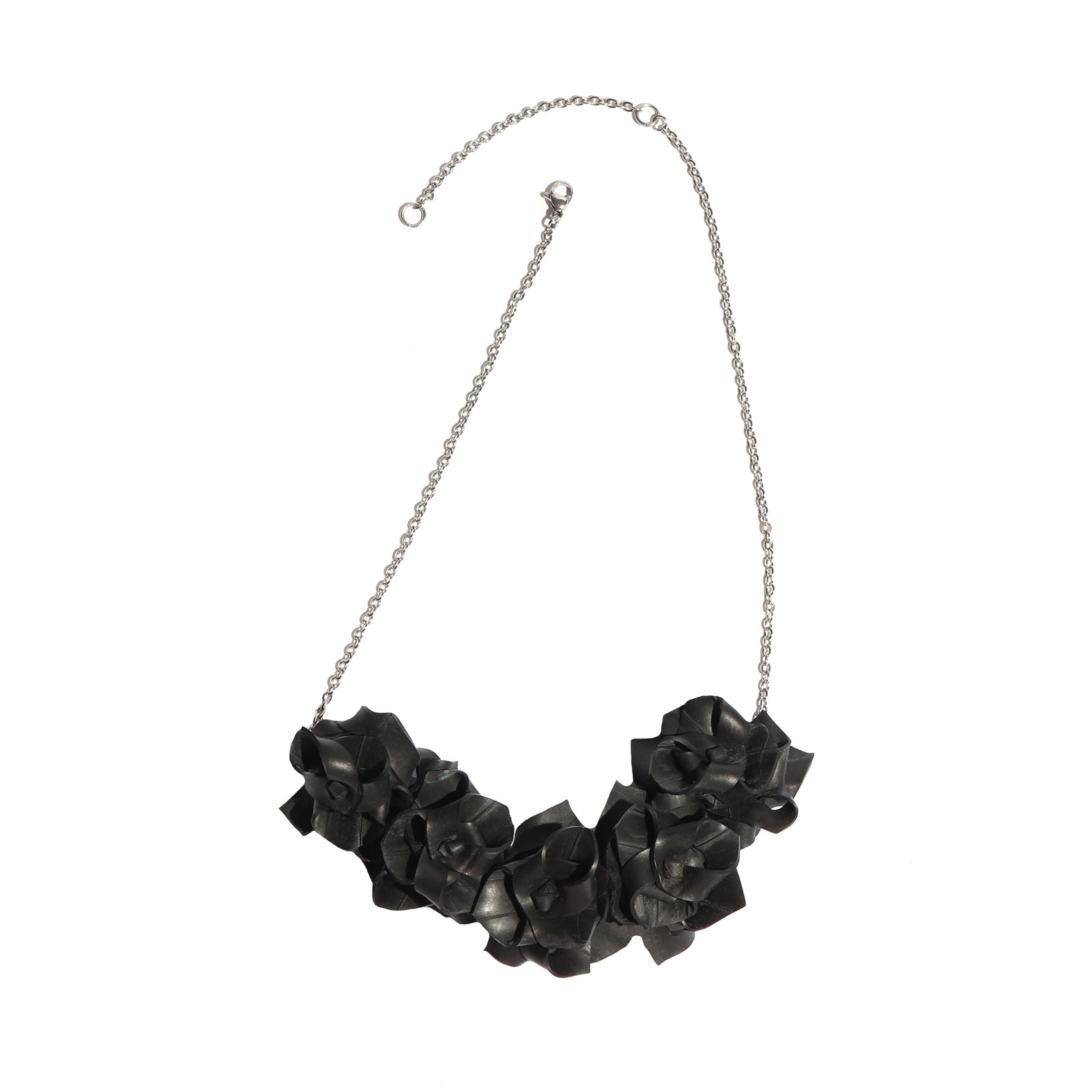 Black rose-shaped necklace on a white background