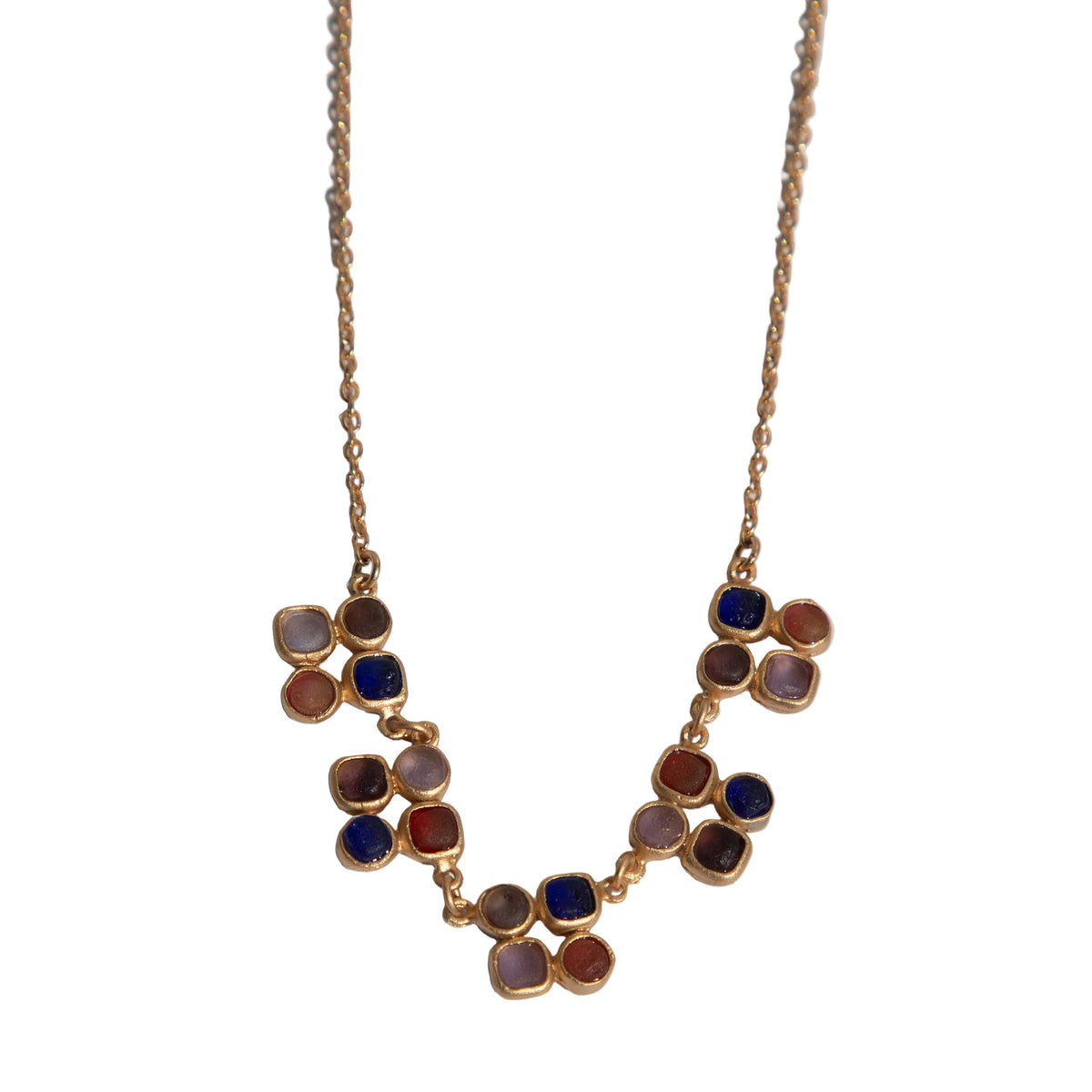 Necklace with multicolored circular pendants on a light gray background