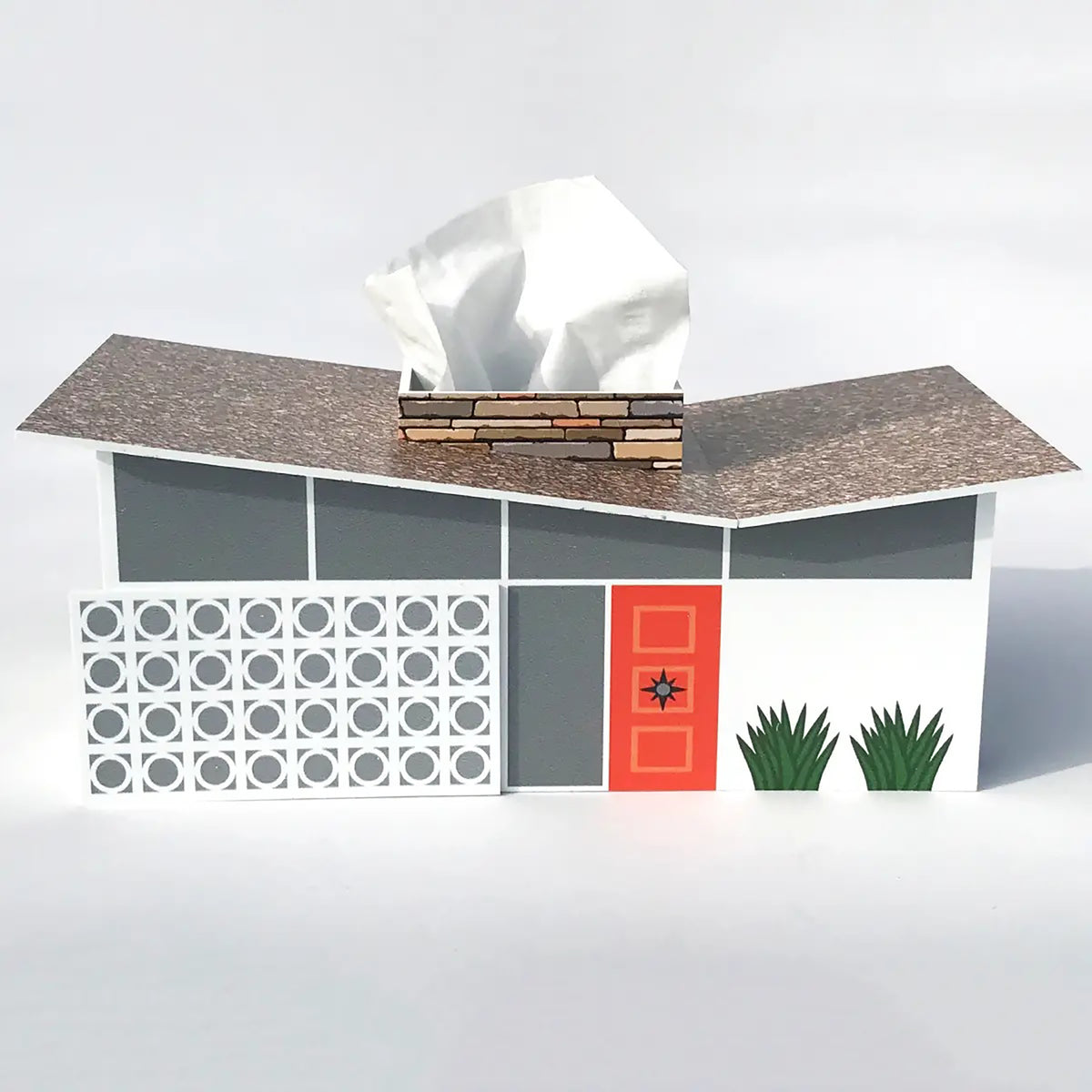 A mid-century modern house-shaped tissue box cover with a white tissue protruding from the roof, shown on a clean white background.