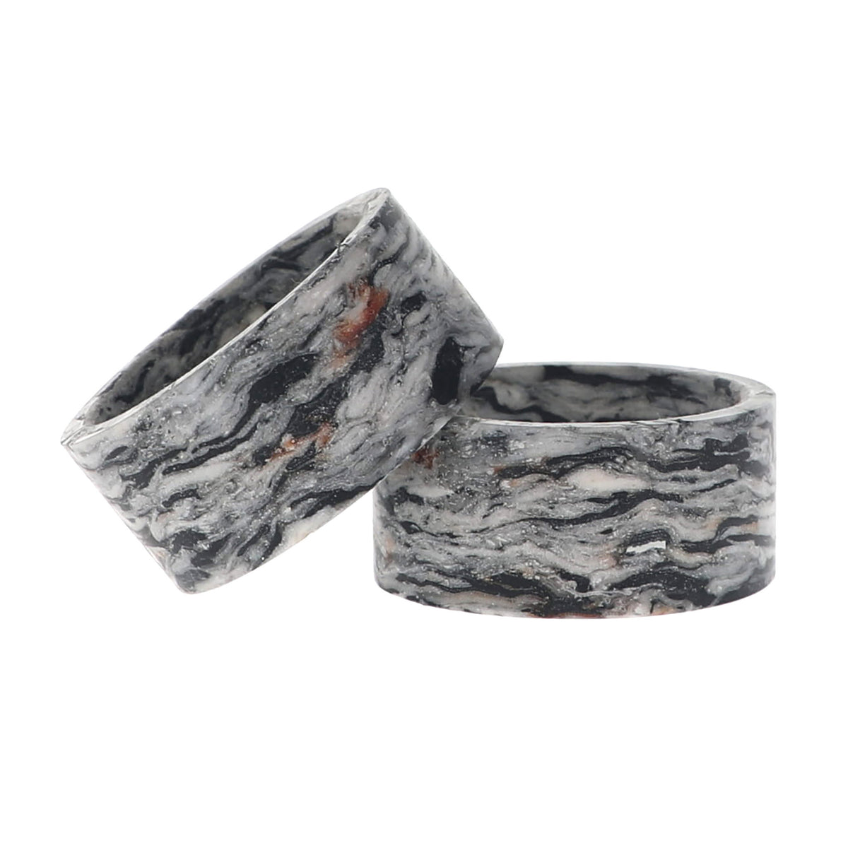 Two napkin rings with a black, white, and gray marbled pattern, displayed on a clean white background.