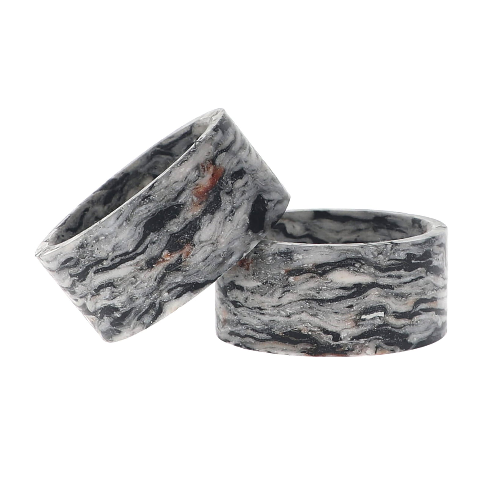 A napkin ring with swirling black, gray, white, and subtle warm brown veins, shown on a plain white background.