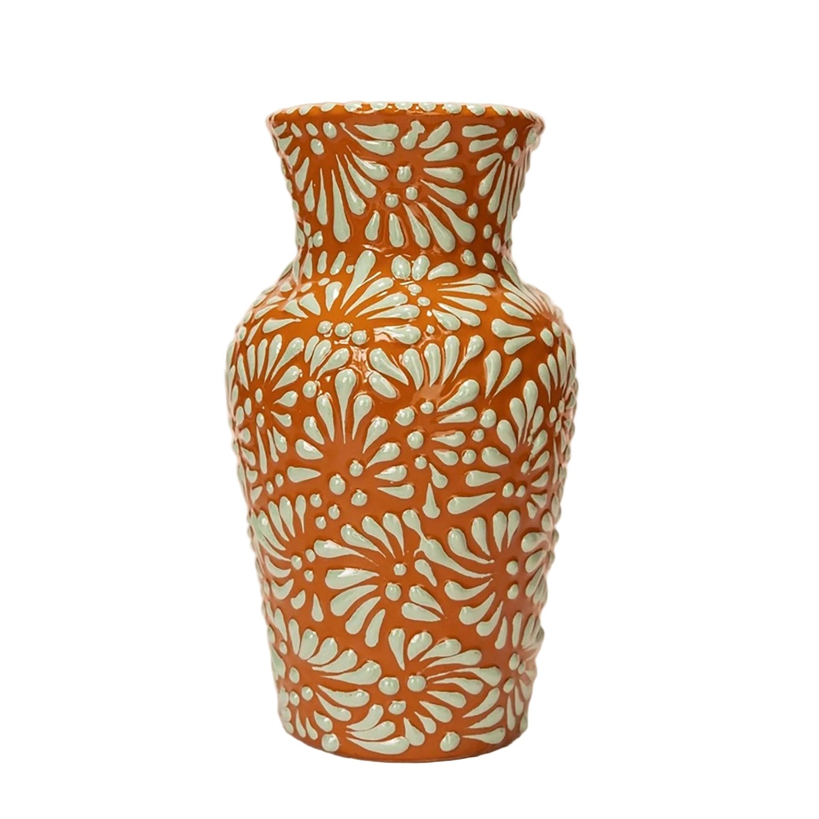 A small ceramic vase with a textured, ribbed body and a flared rim, decorated with a repeating light mint green floral pattern over a warm terracotta orange base.