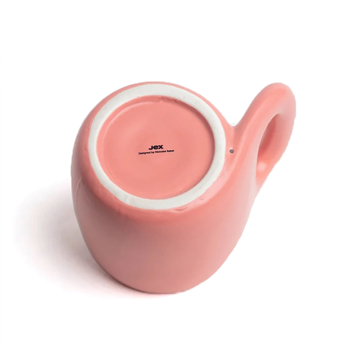 A pink ceramic mug with a loop handle, shown from a top-down angle on a white background, revealing the JAX brand name printed on the inside bottom.