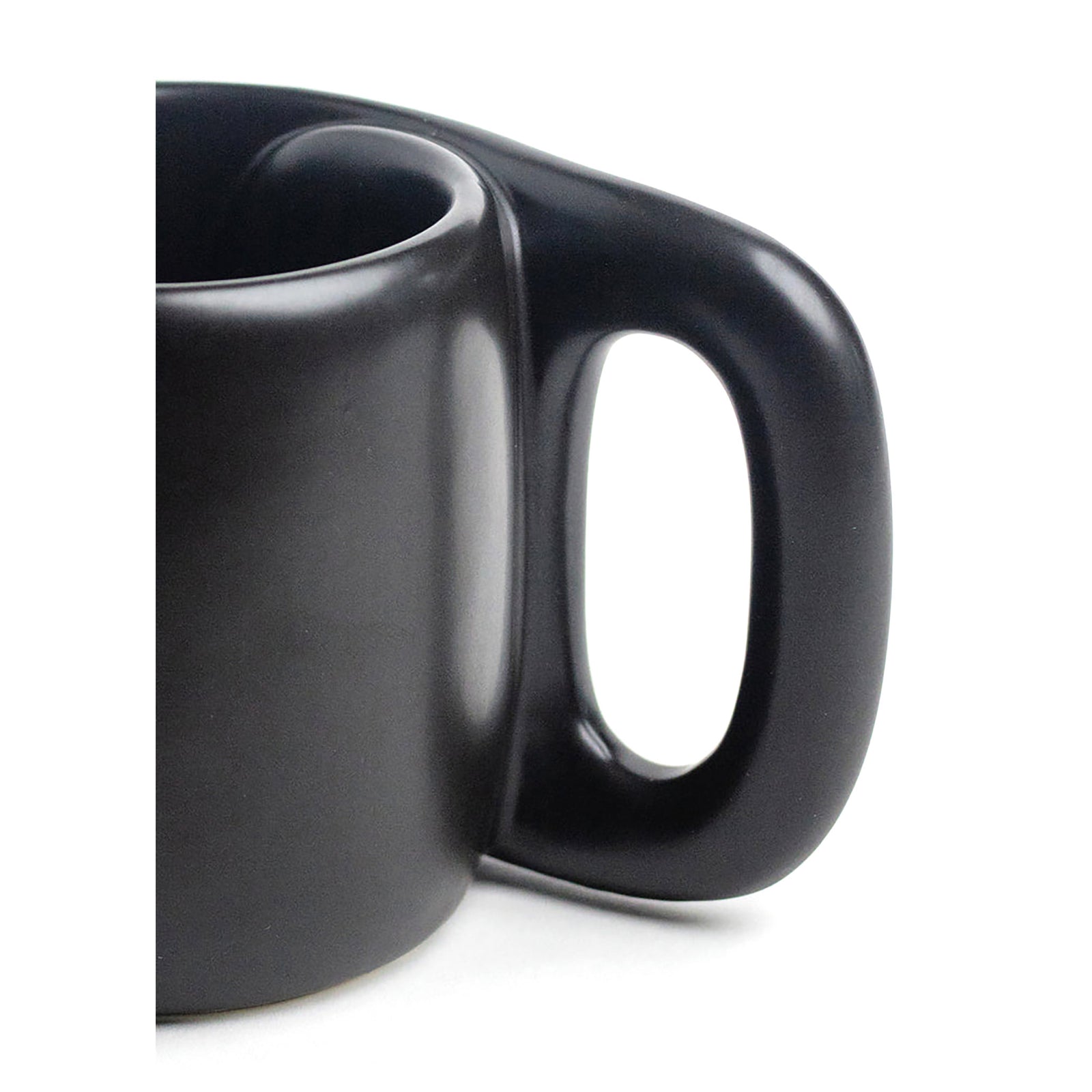 A matte black ceramic mug with a unique, integrated handle, shown on a clean white background.