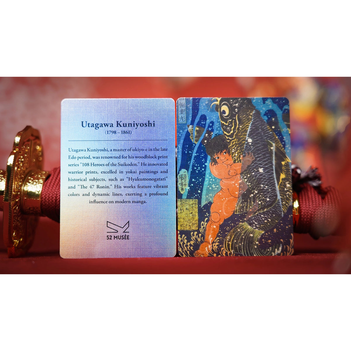 Two art cards displayed side-by-side on a red surface. The left card is a light blue biographical card titled 'Utagawa Kuniyoshi (1798-1862)' with text and the 'S2 MUSÉE' logo.