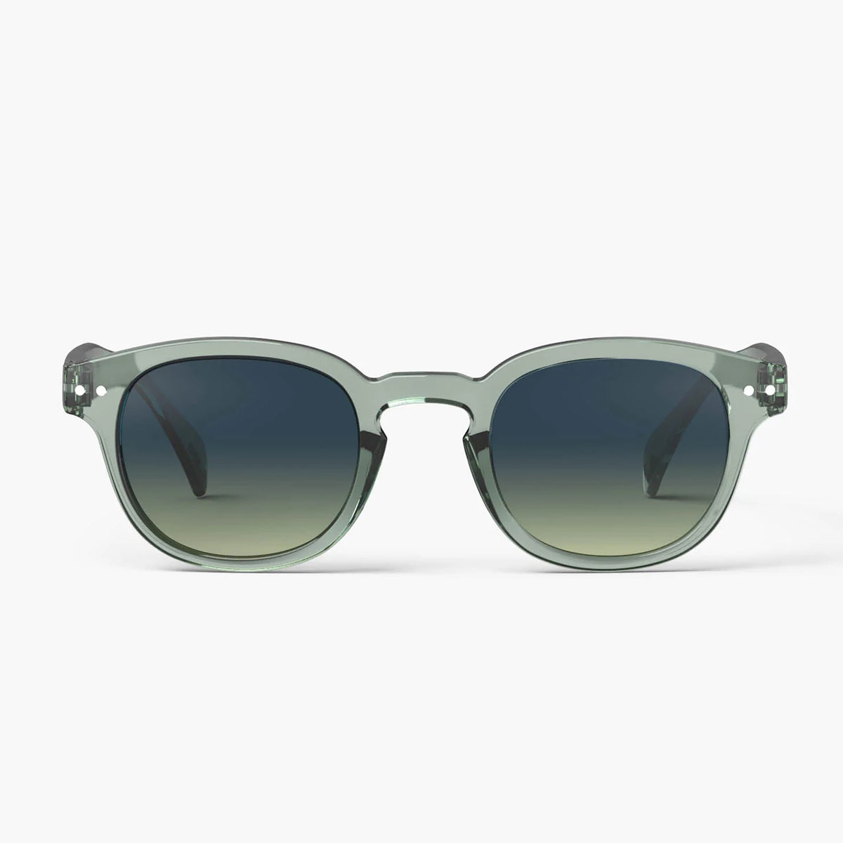 Oversized square sunglasses with translucent sage green frames and dark gradient lenses, shown against a light gray background.