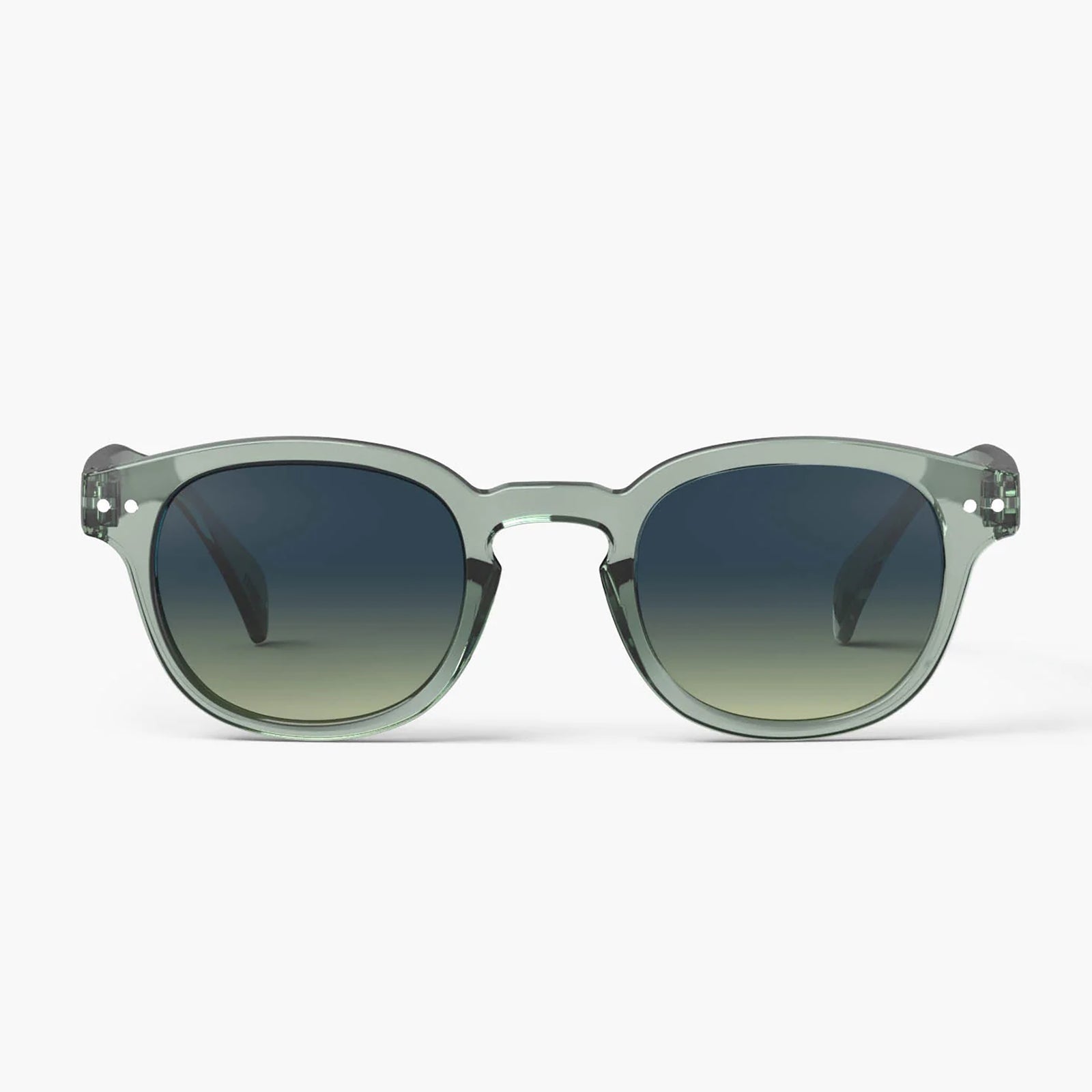Oversized square sunglasses with translucent sage green frames and dark gradient lenses, shown against a light gray background.