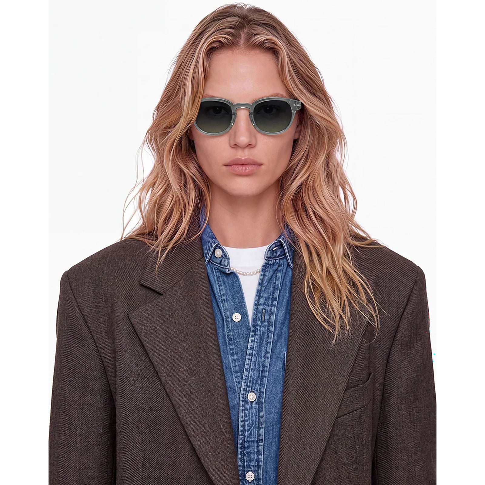 Oversized square sunglasses with translucent sage green frames and dark gradient lenses, shown against a light gray background.