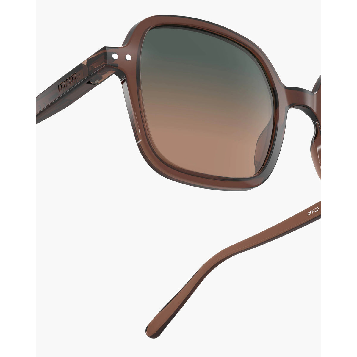 Close-up of a pair of sunglasses with a translucent brown acetate frame and gradient brown lenses, shown on a light gray background.