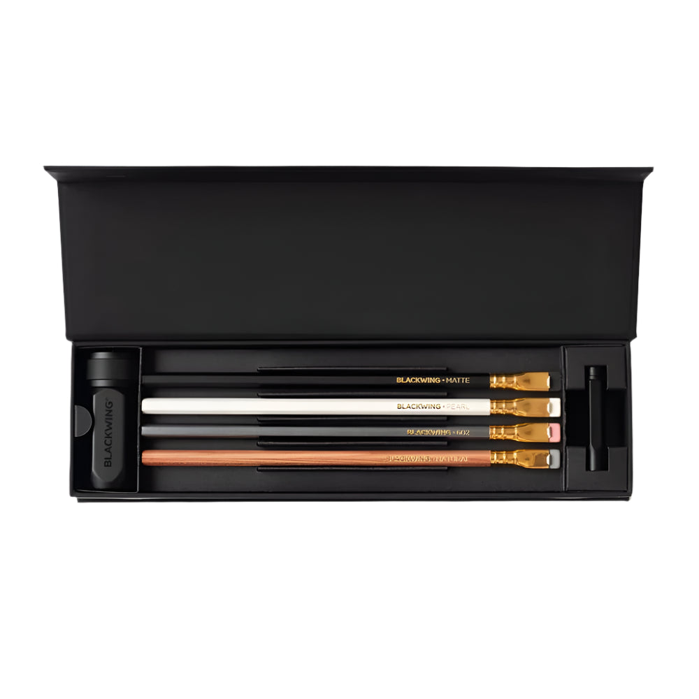 Set of Blackwing pencils, a sharpener, and a point case in a black box on a white background