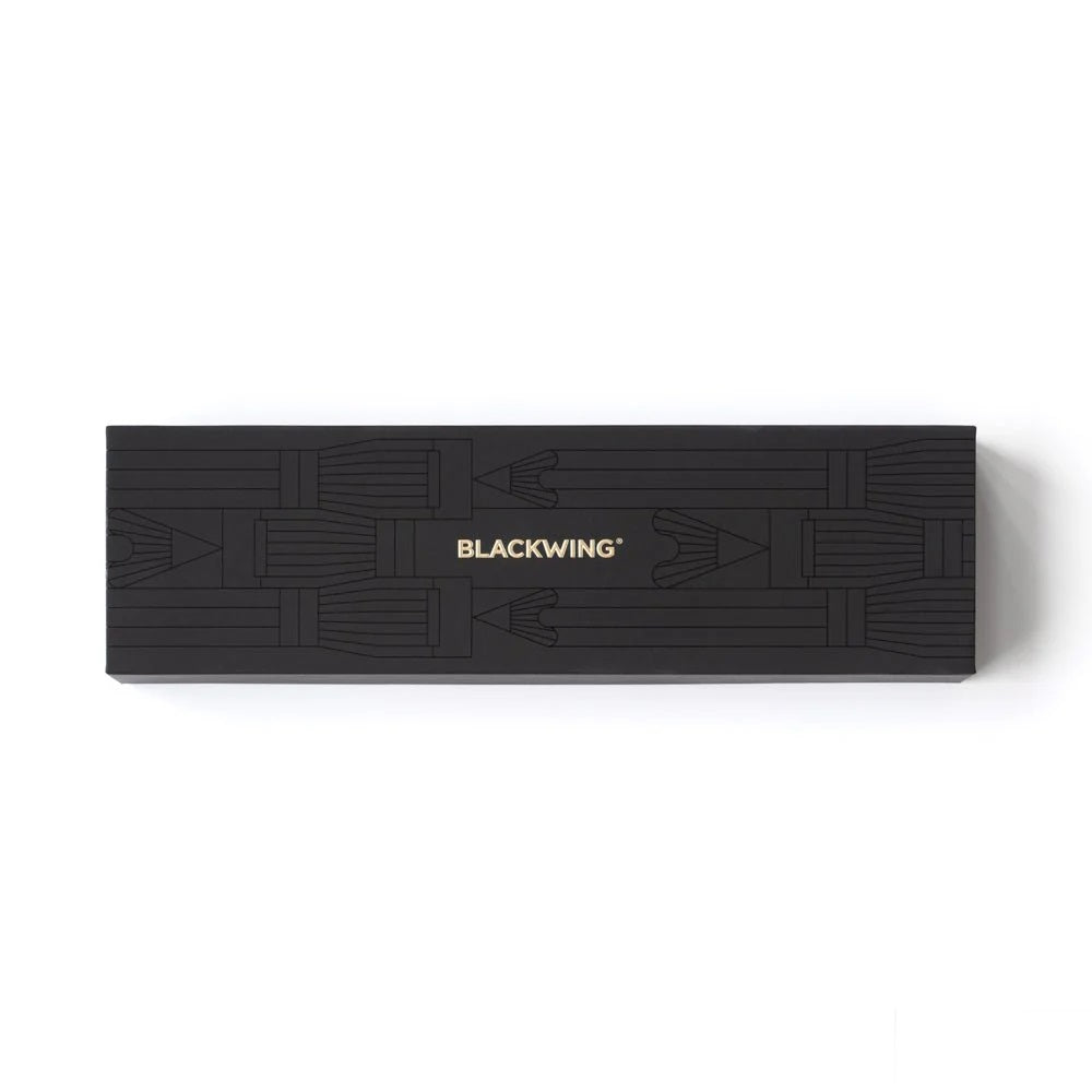 Set of Blackwing pencils, a sharpener, and a point case in a black box on a white background