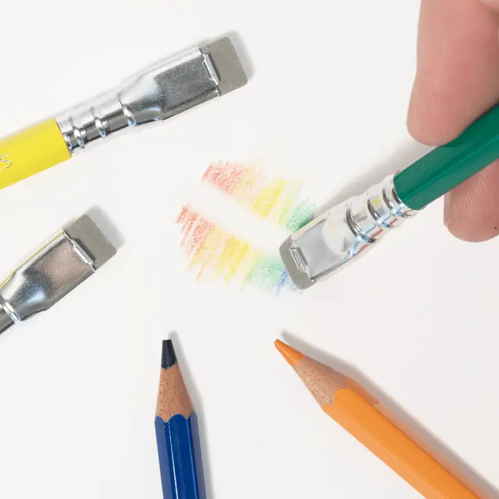 Colorful pencils and paintbrushes on a white background