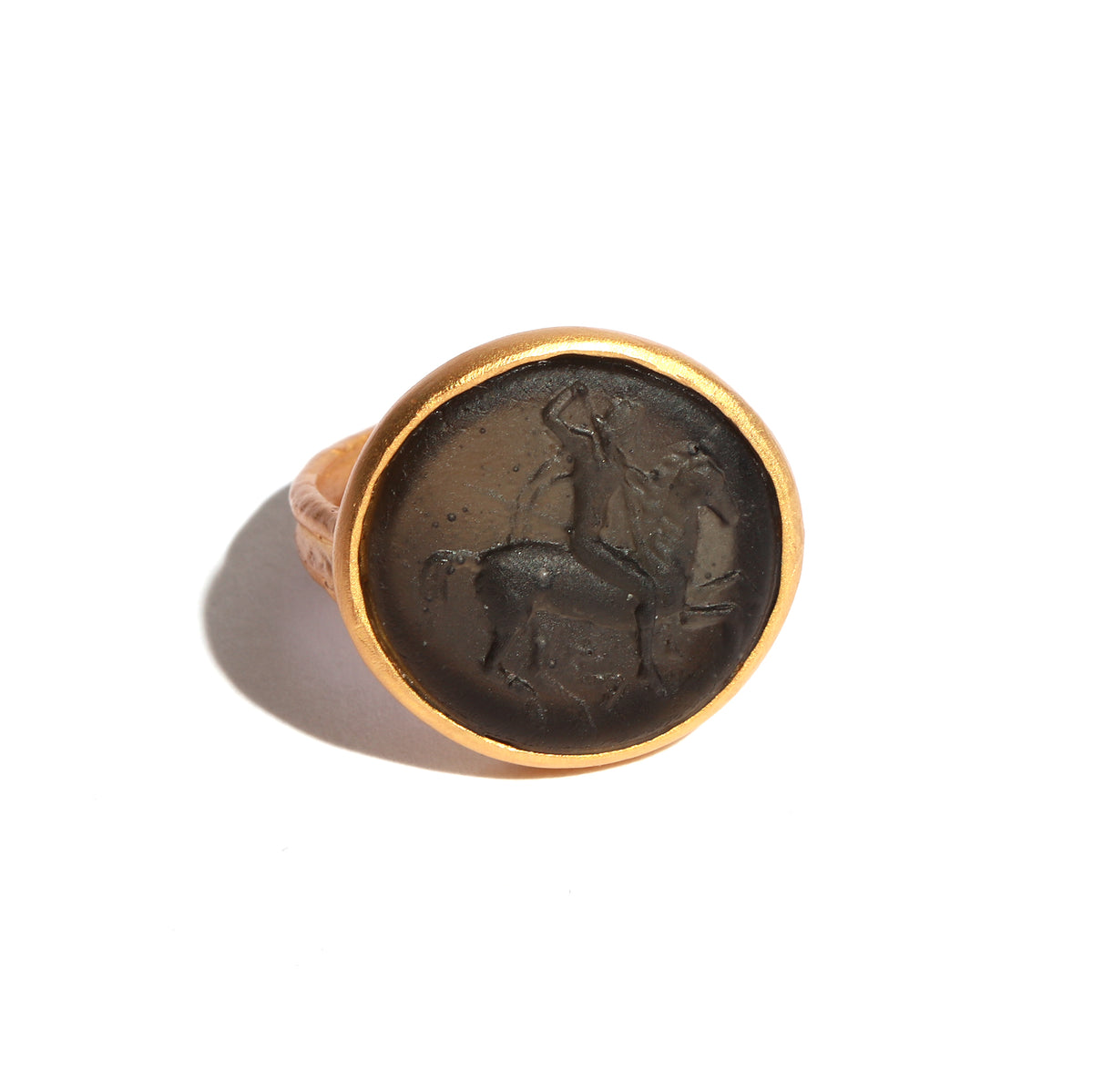 Bronze ring with a circular design on a white background