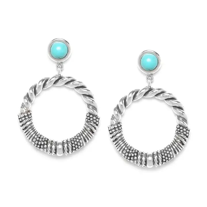 Silver hoop earrings with turquoise stones on a white background