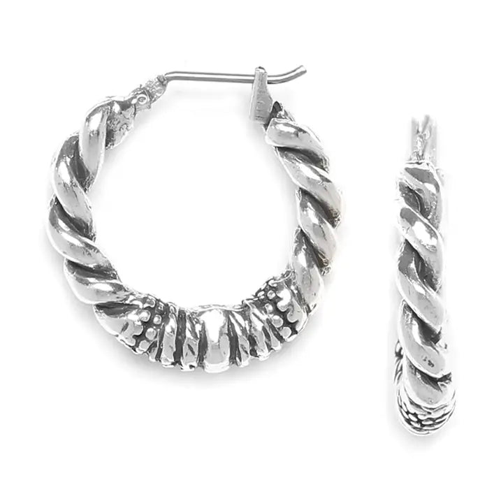 Silver hoop earrings with twisted design on a white background