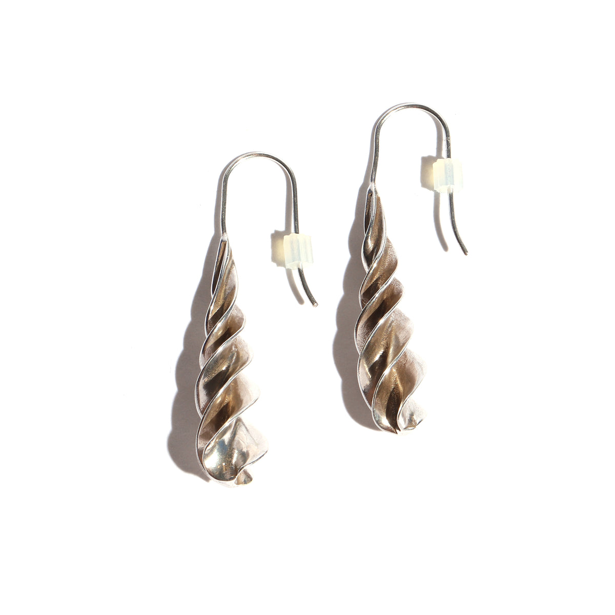 Silver spiral earrings on a white background