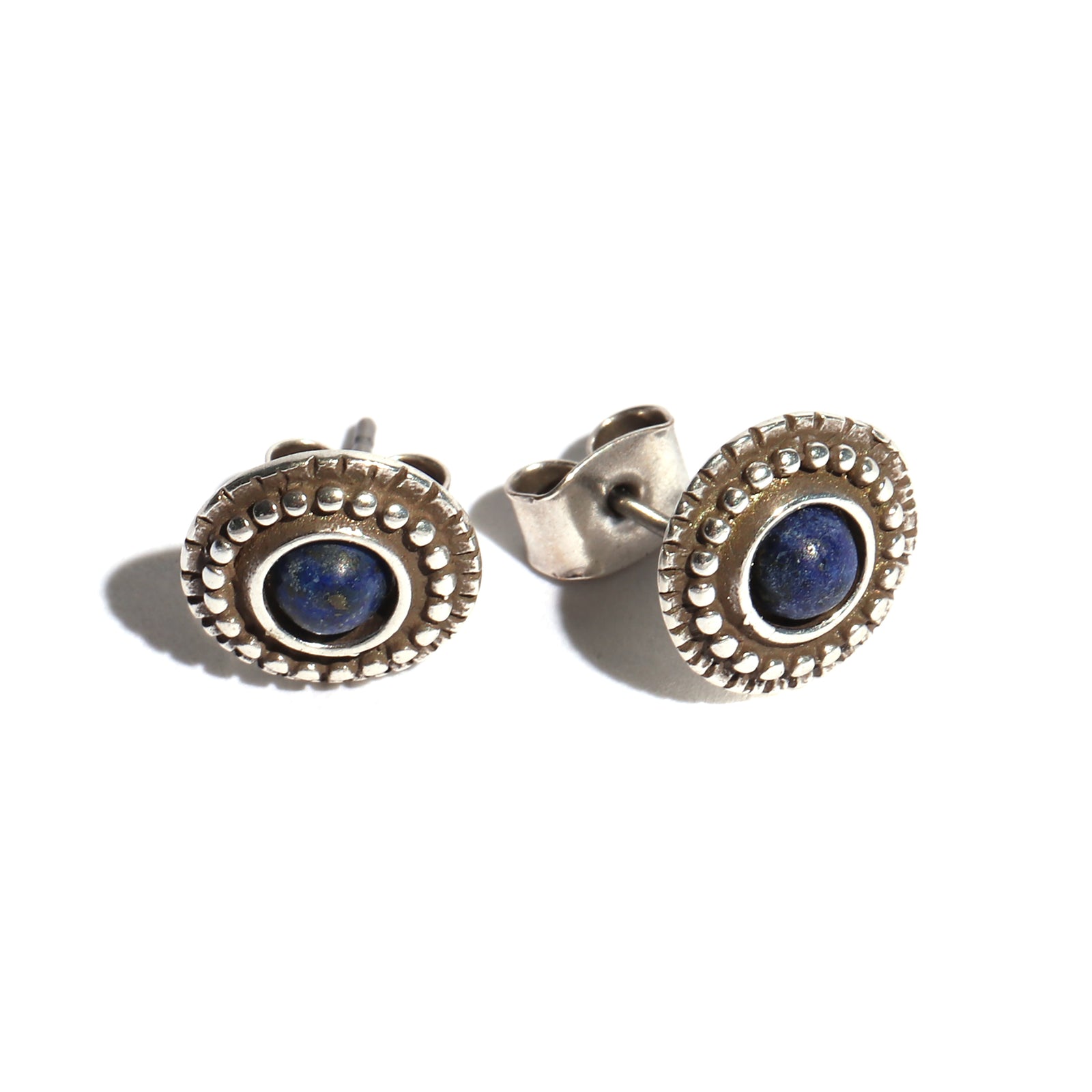 Silver stud earrings with blue gemstones on a white background