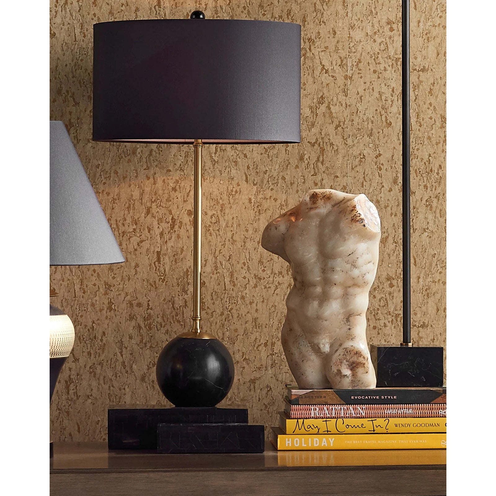 Carved stone figure of a torso on a white background