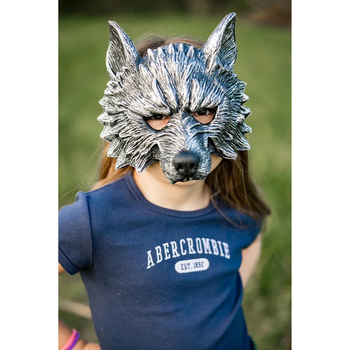 Person wearing a wolf mask outdoors