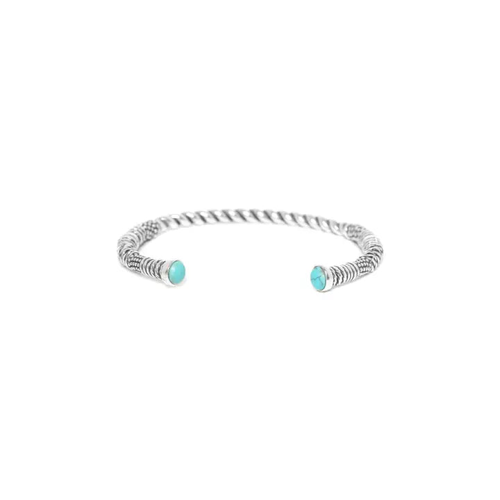 Silver bracelet with turquoise beads on a white background