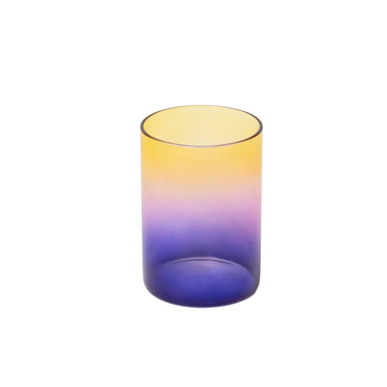 Gradient glass tumbler transitioning from yellow to blue on a white background