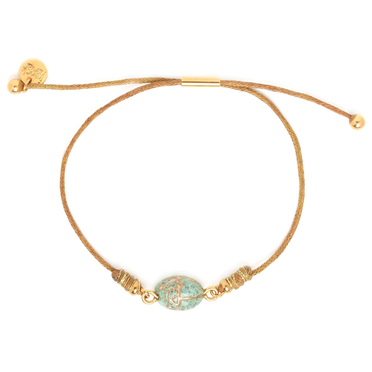 Gold bracelet with a green bead on a white background