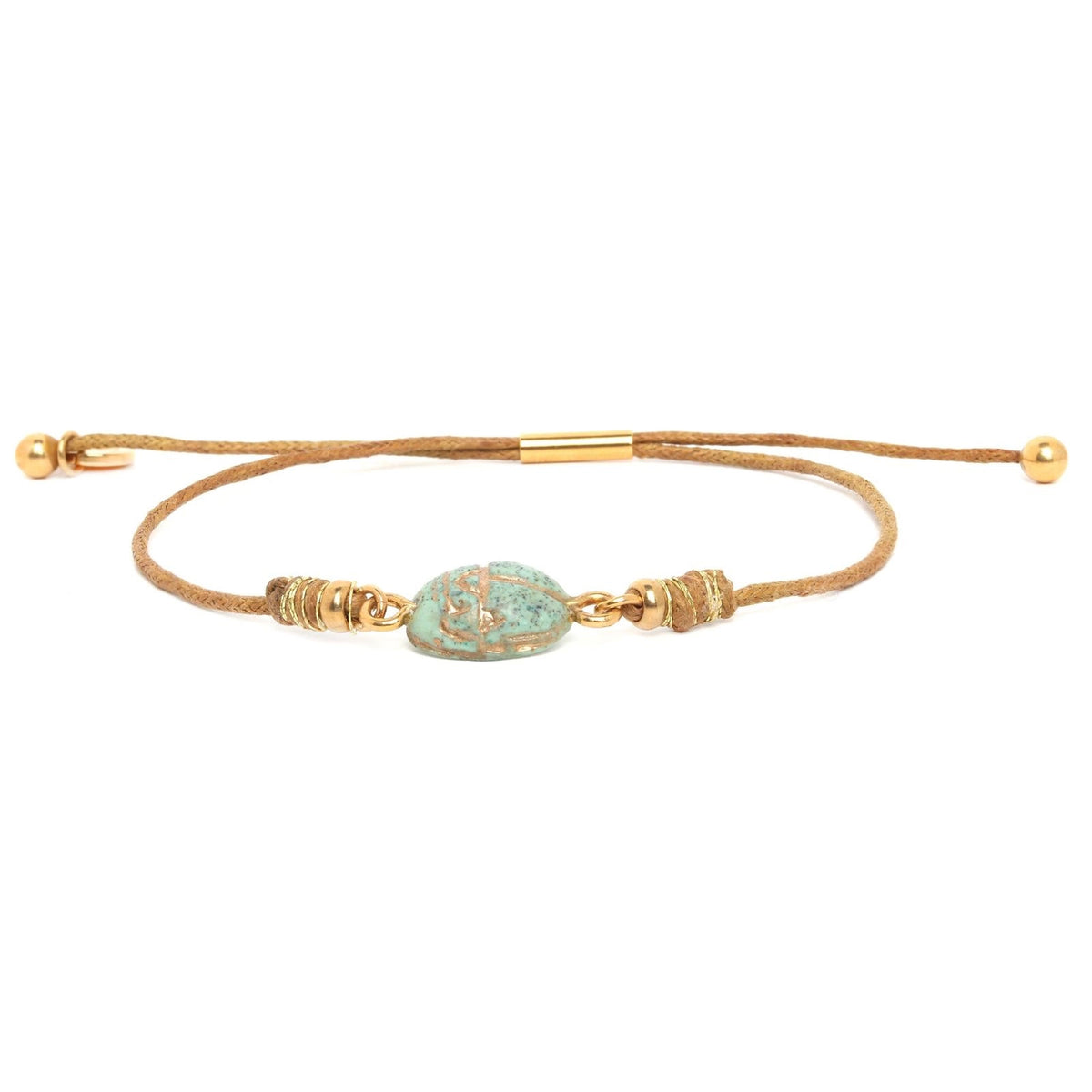 Gold bracelet with a green bead on a white background