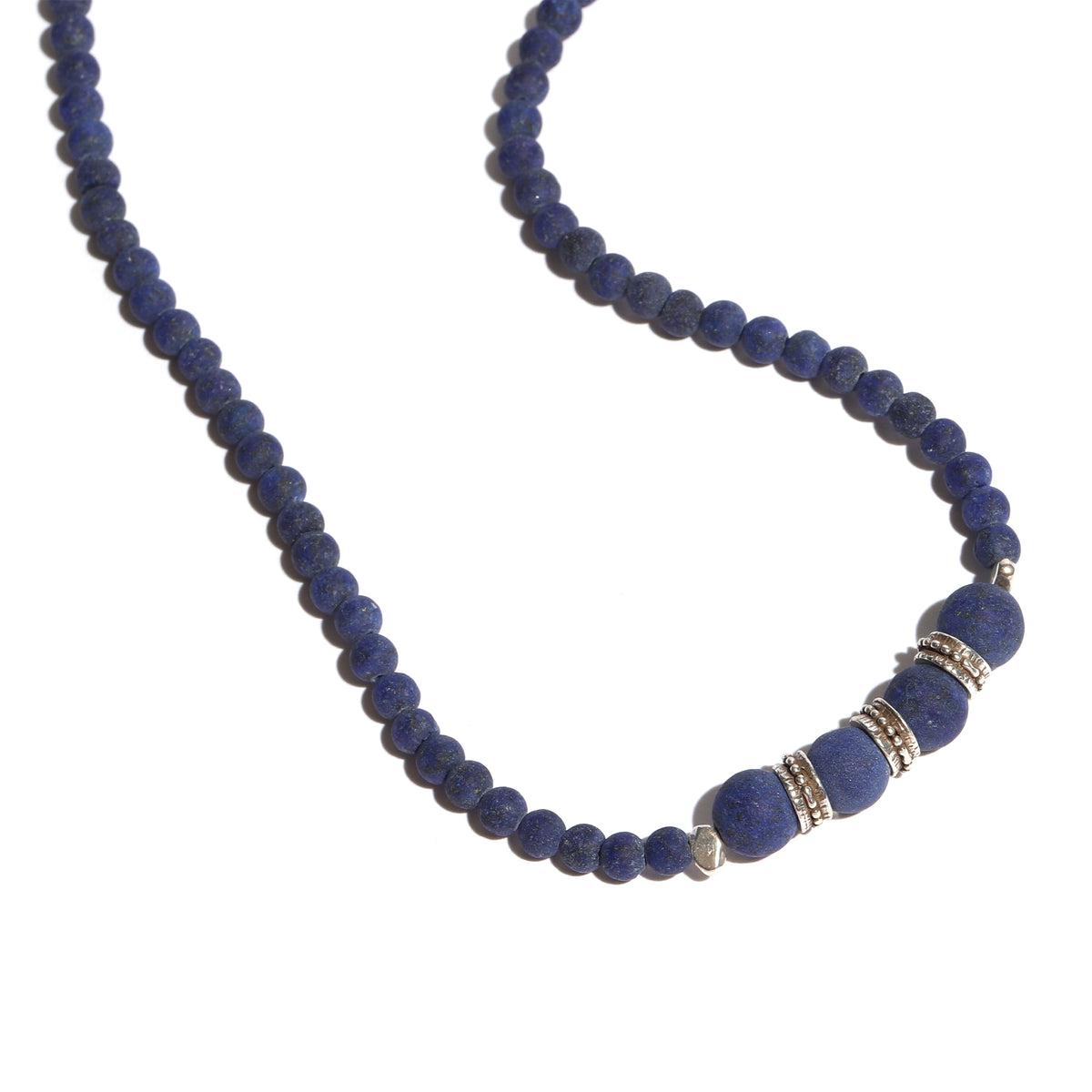 Blue beaded necklace with silver clasp on a white background