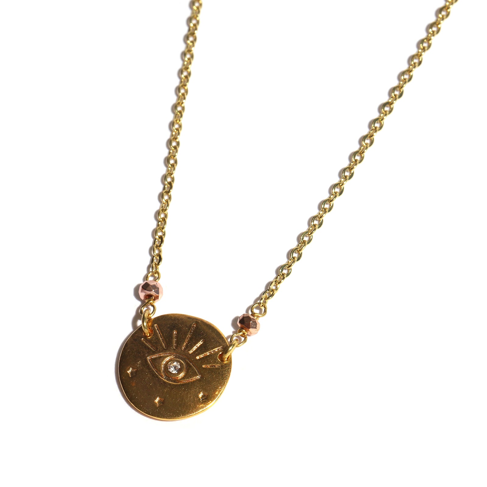 Gold necklace with a circular pendant featuring an eye design on a white background