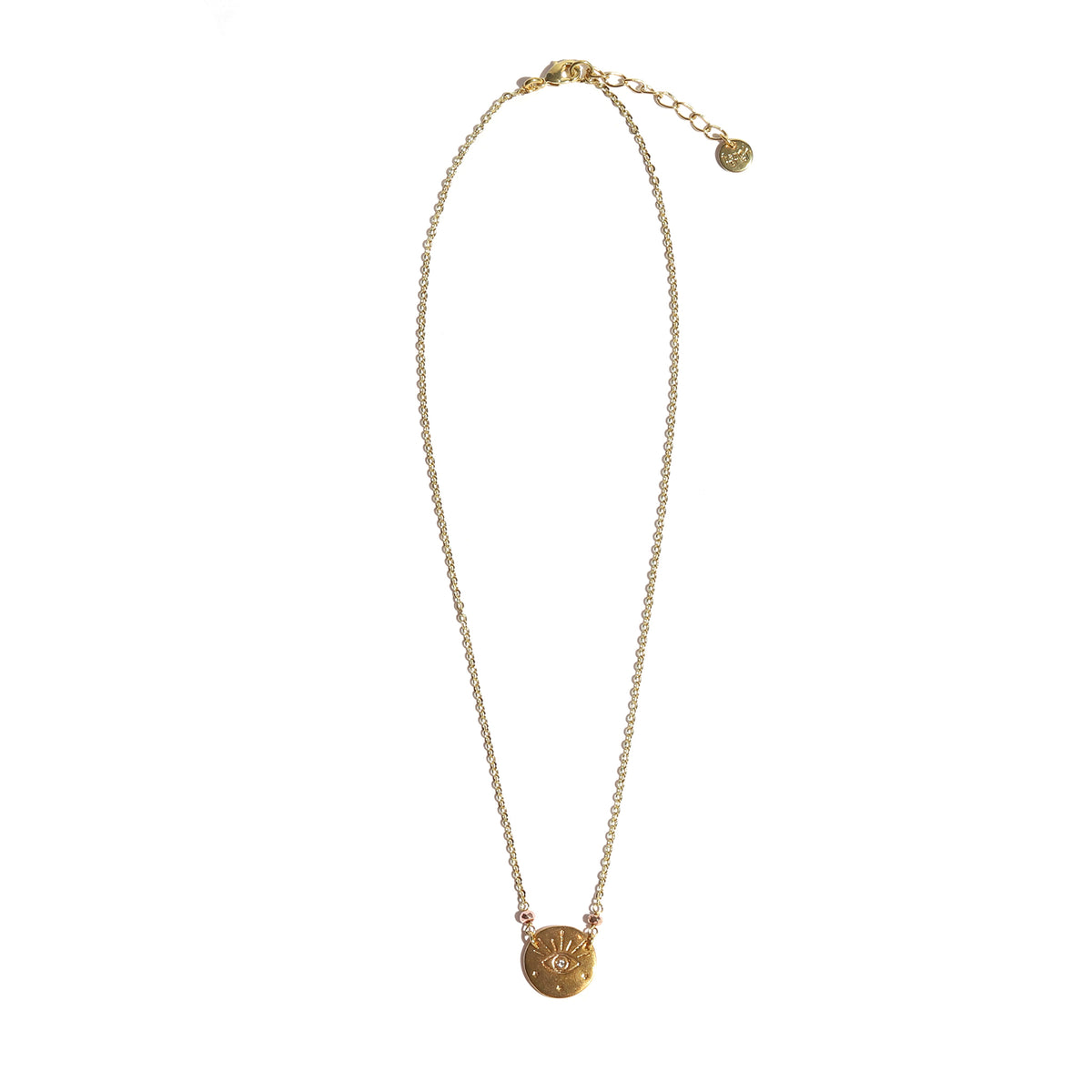Gold necklace with a round pendant on a white background