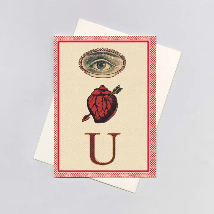 Greeting card with eye, heart, and 'U' design on a beige background