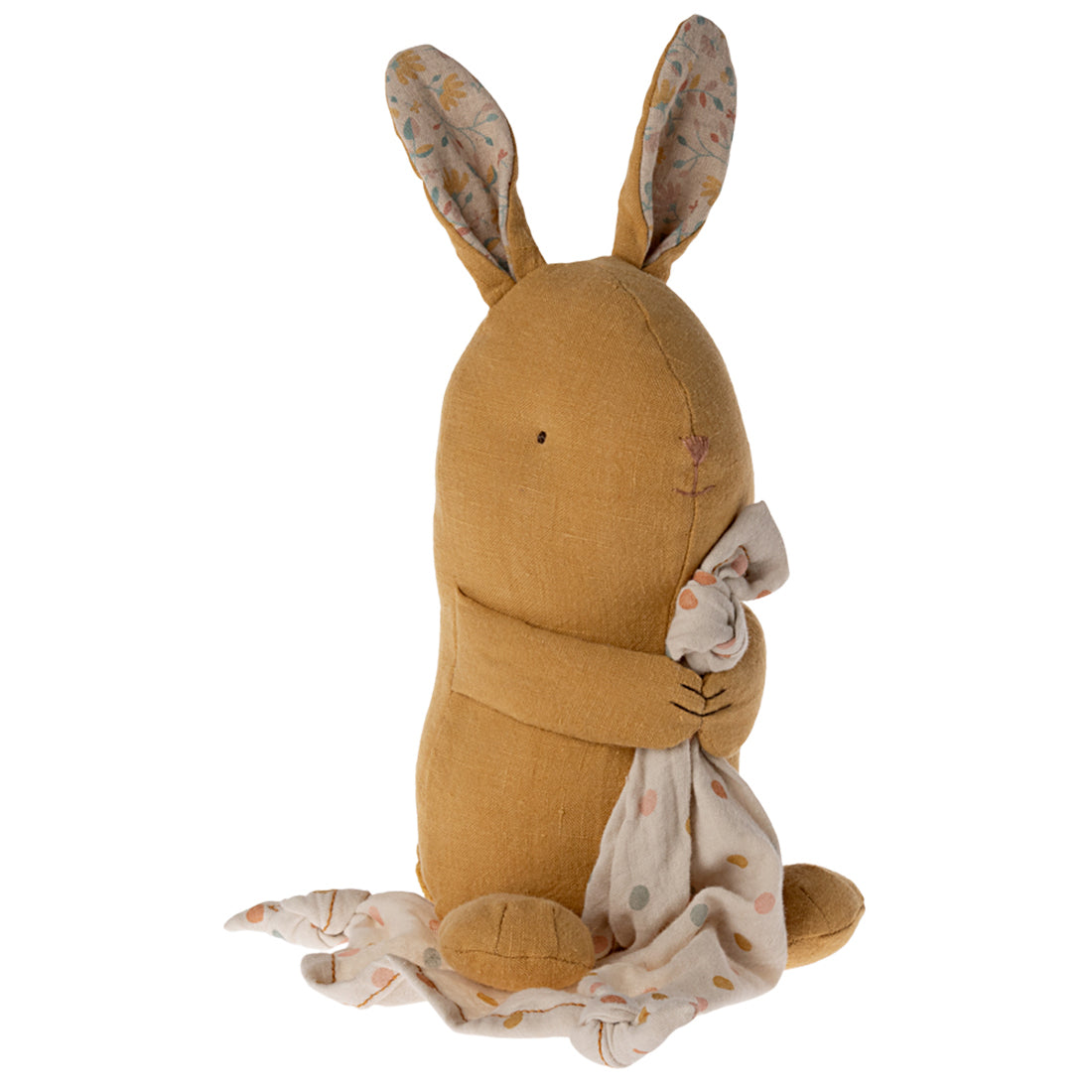 Brown plush rabbit toy with a white blanket on a white background