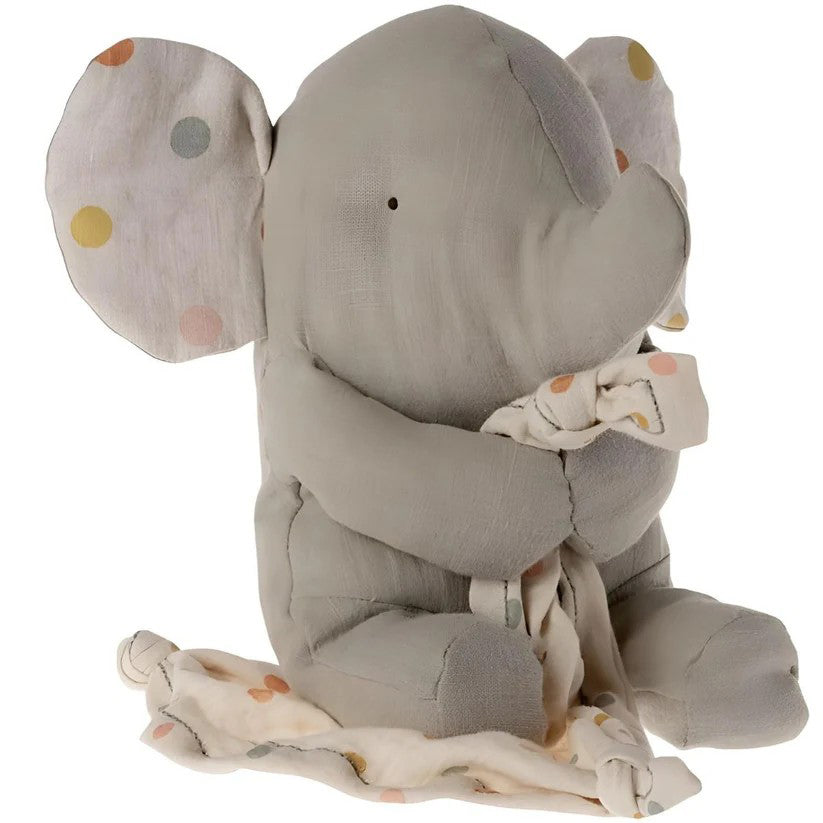 Gray elephant plush toy with a blanket on a white background