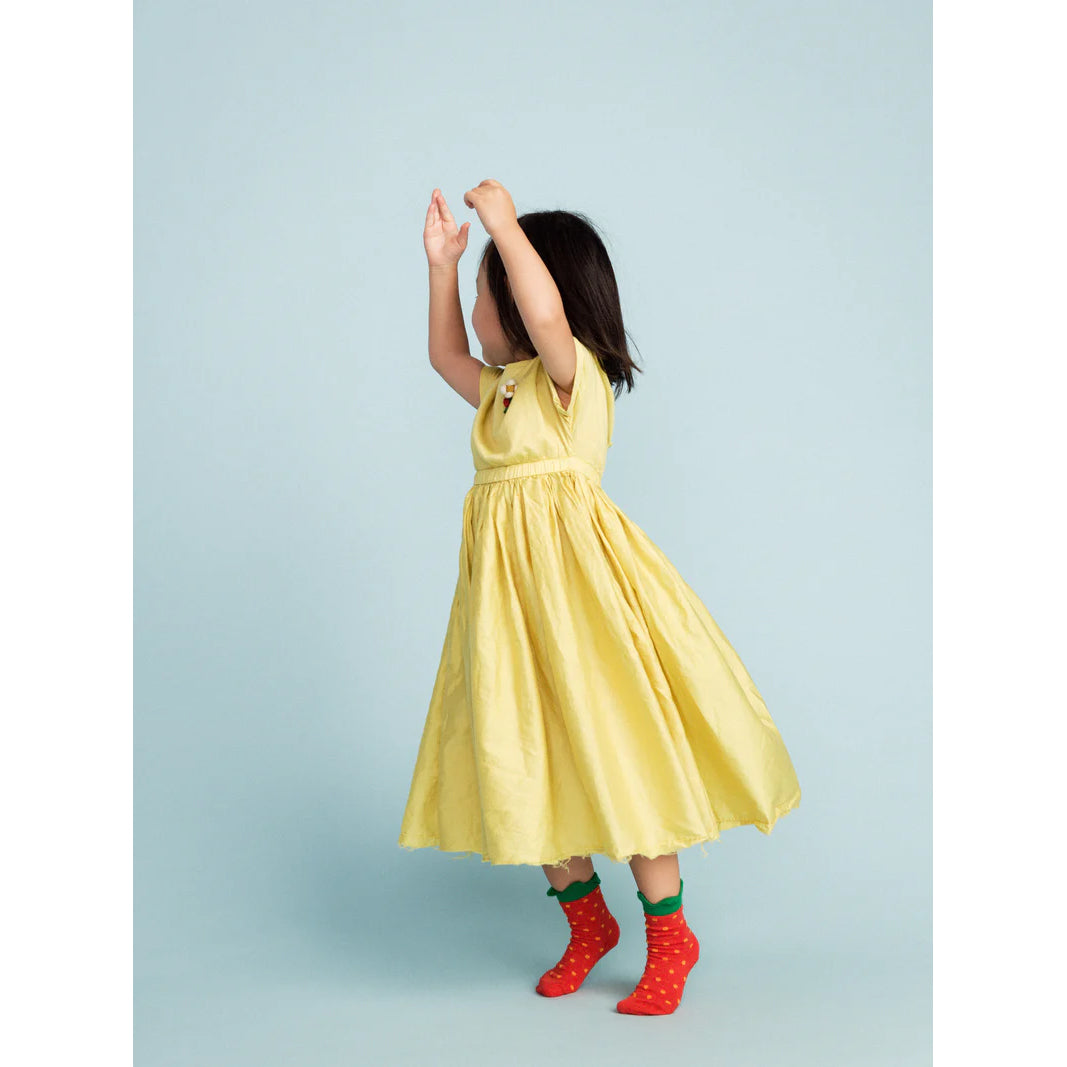 Red socks with green tops resembling strawberries on a white background