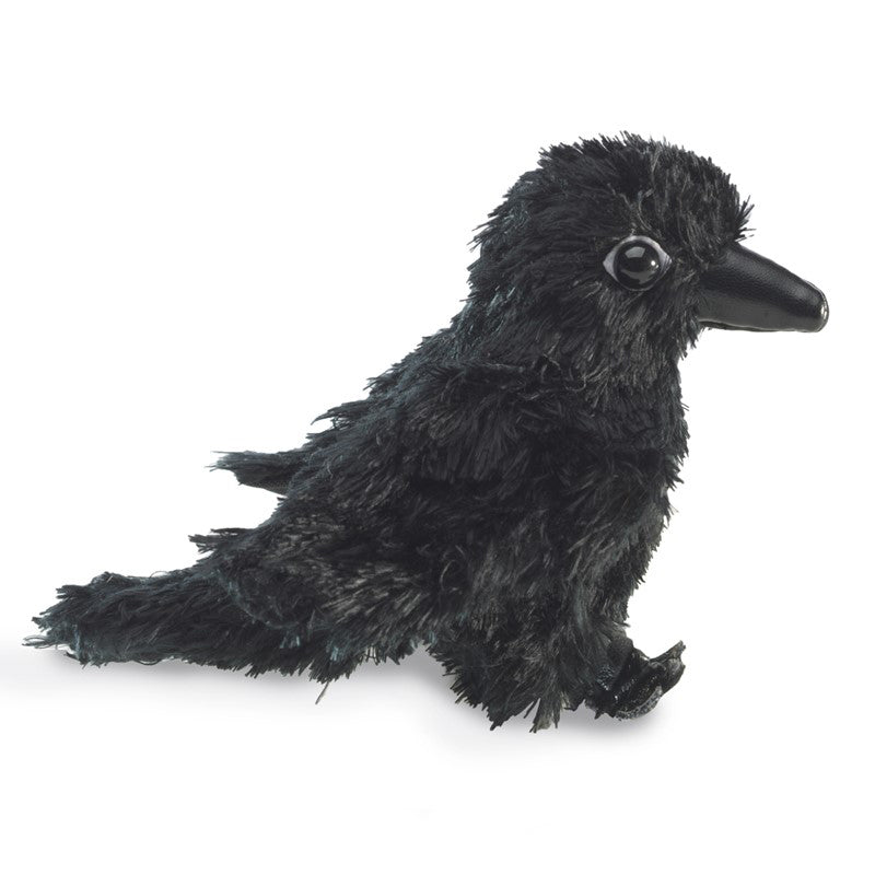 Black plush raven toy on a white background