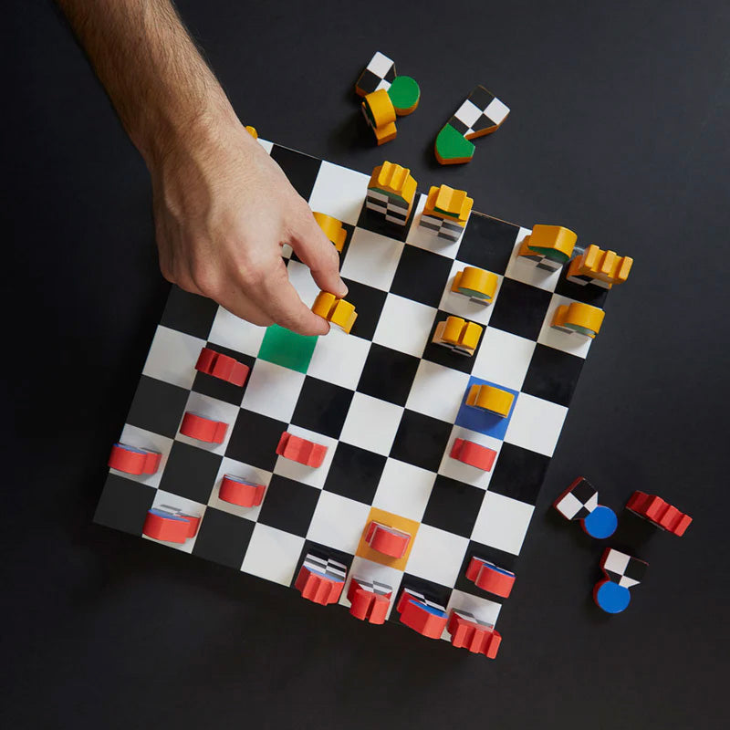 Checkered board game with colorful pieces on a dark background
