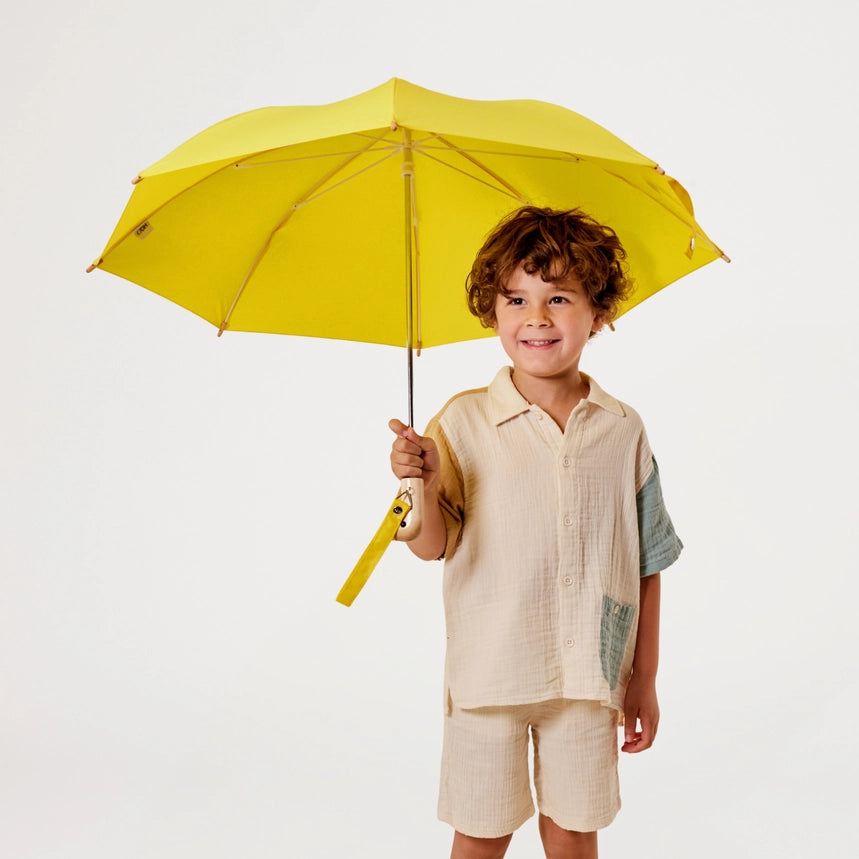 Yellow umbrella with a unique handle on a white background