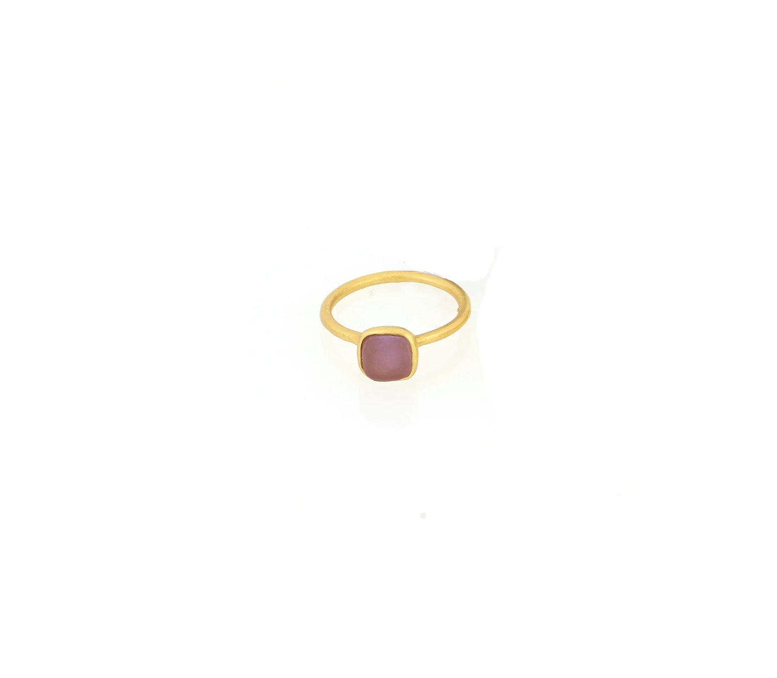 Gold ring with a pink gemstone on a white background
