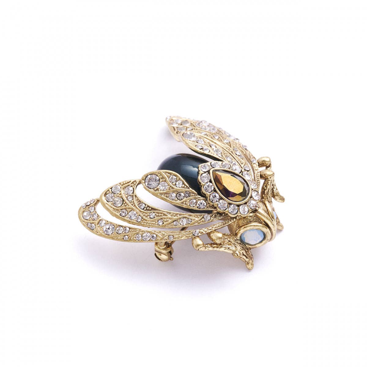 Decorative brooch with gold detailing and a black central gem on a white background