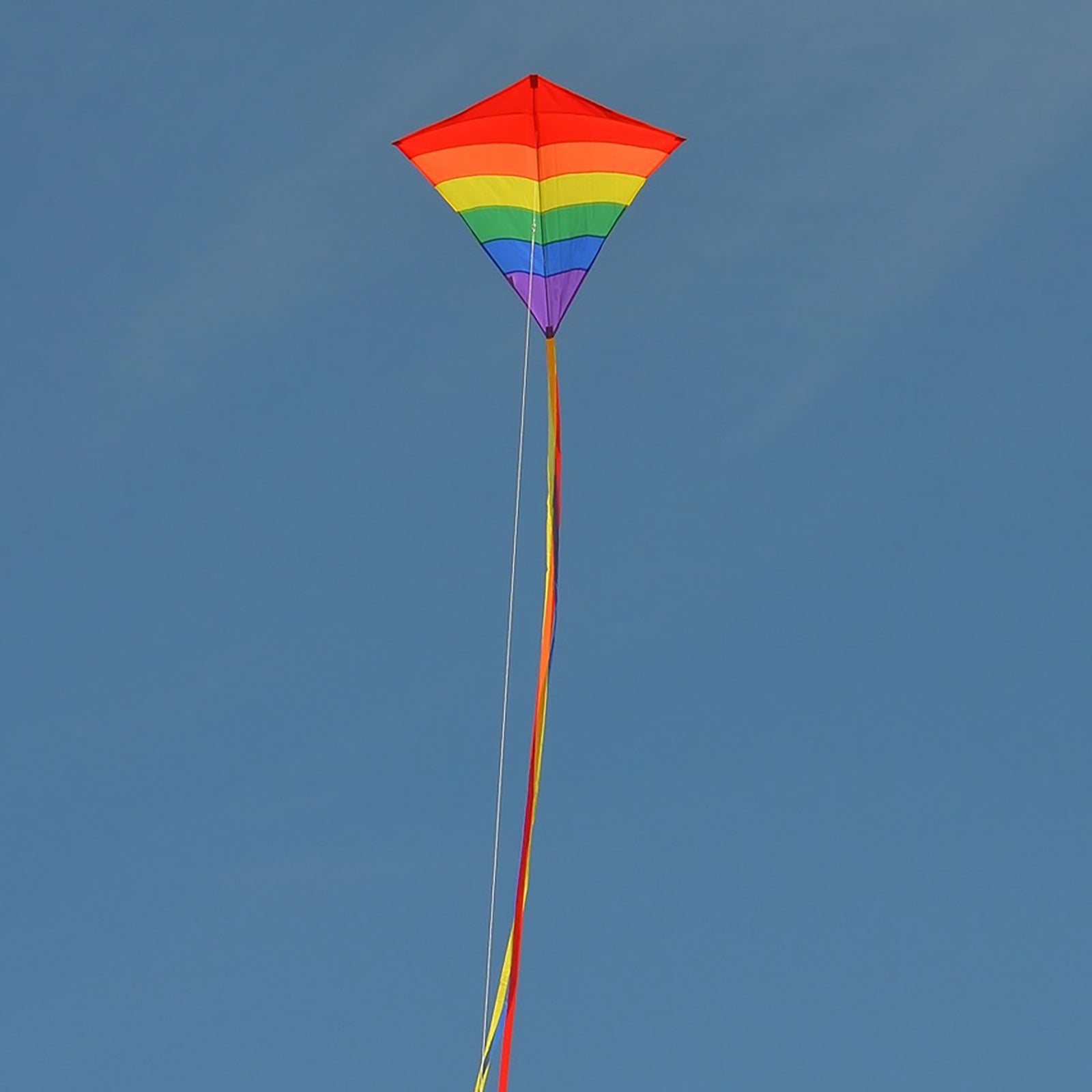 A colorful 39-inch diamond-shaped kite with a rainbow arch design and flowing tails.