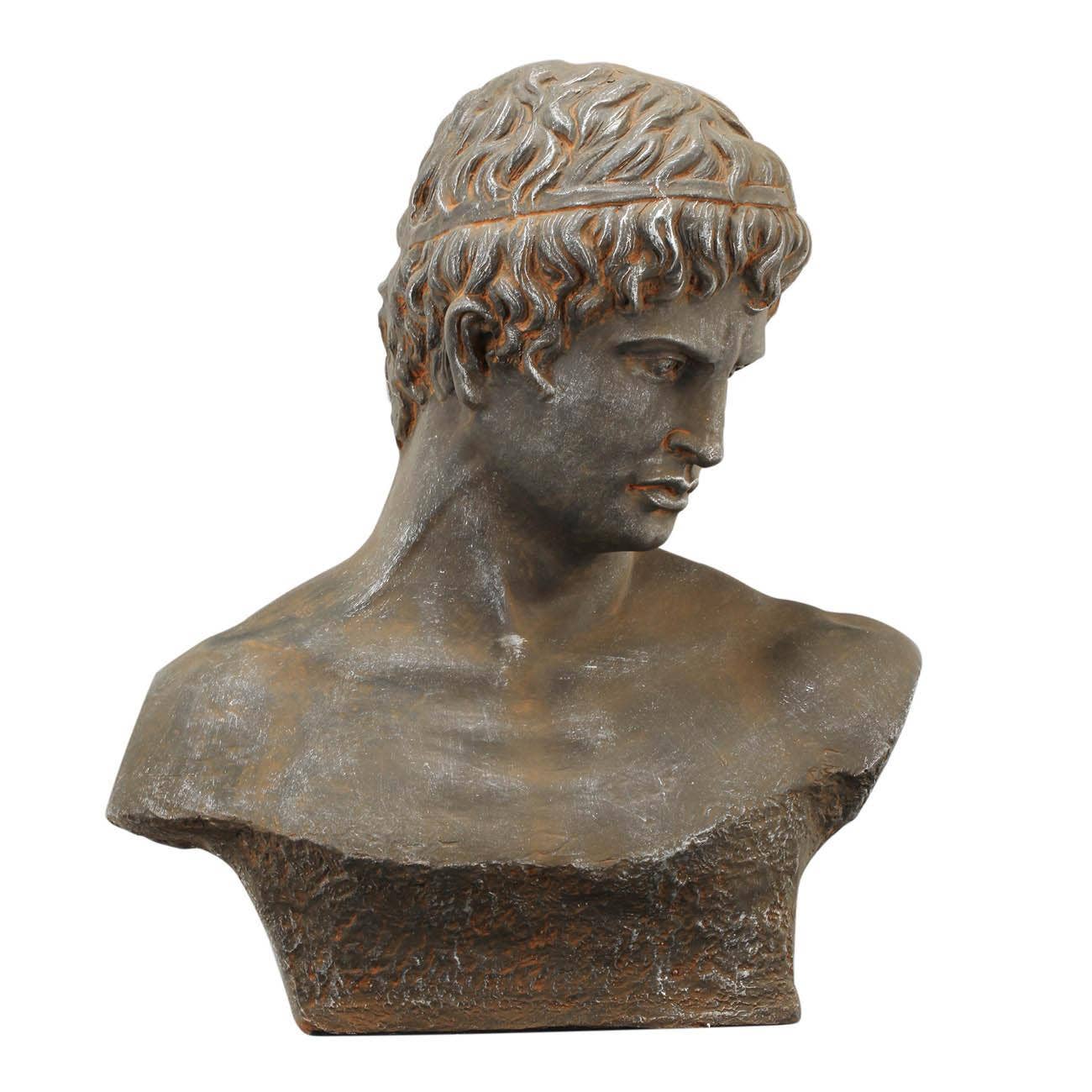 Bronze bust of a classical figure on a white background