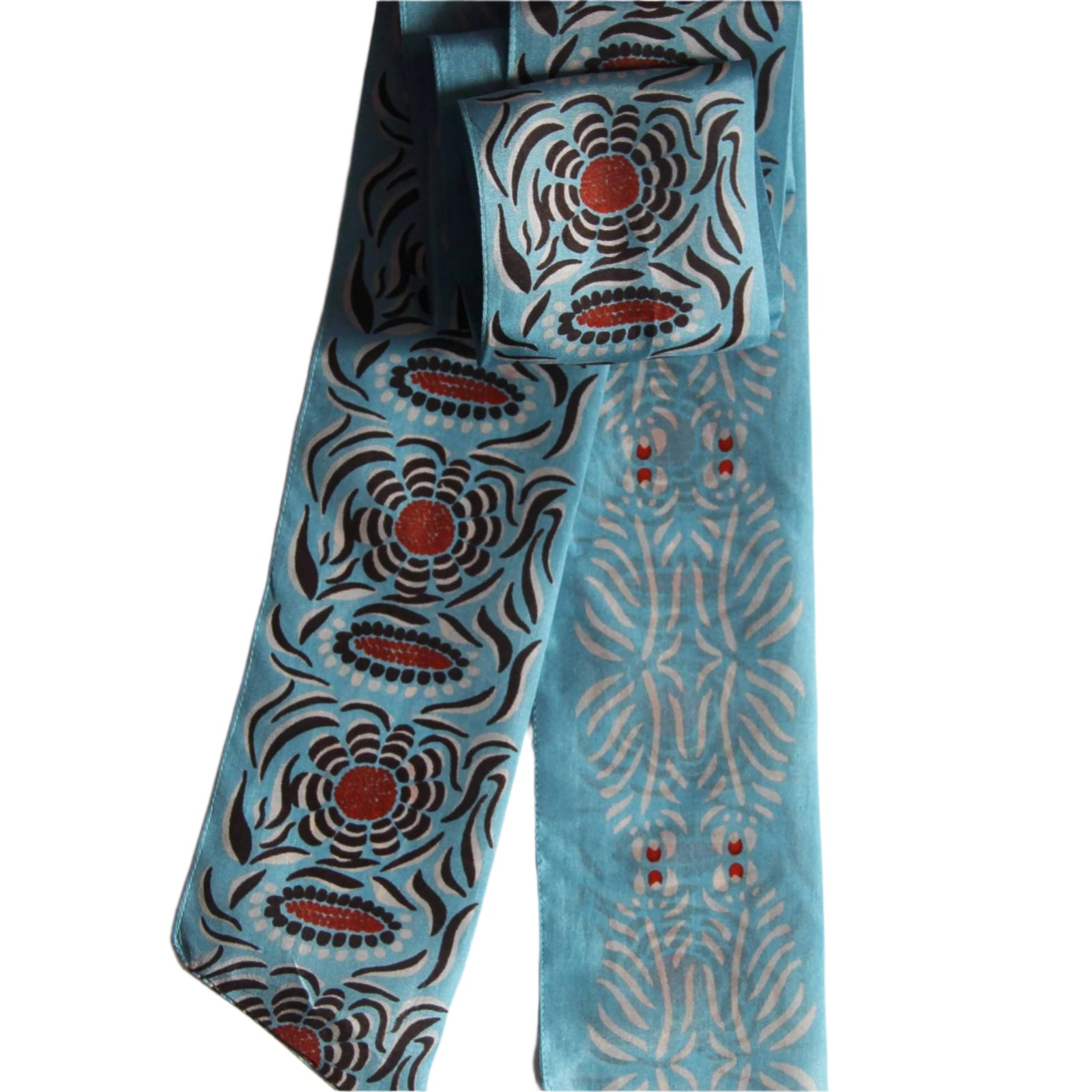 A blue silk headband with red patterned designs, displayed against a white background.