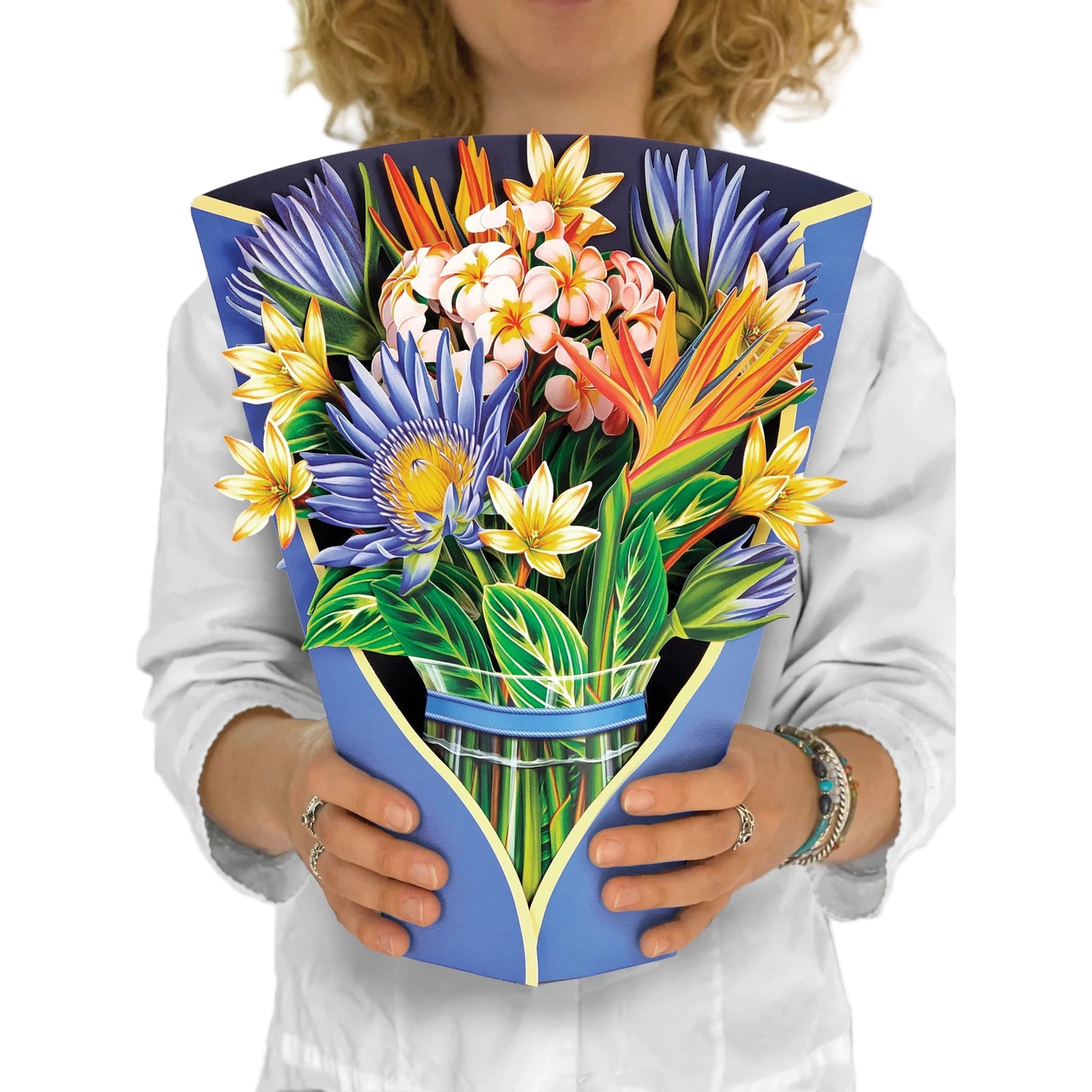 Person holding a colorful paper bouquet with a blue holder