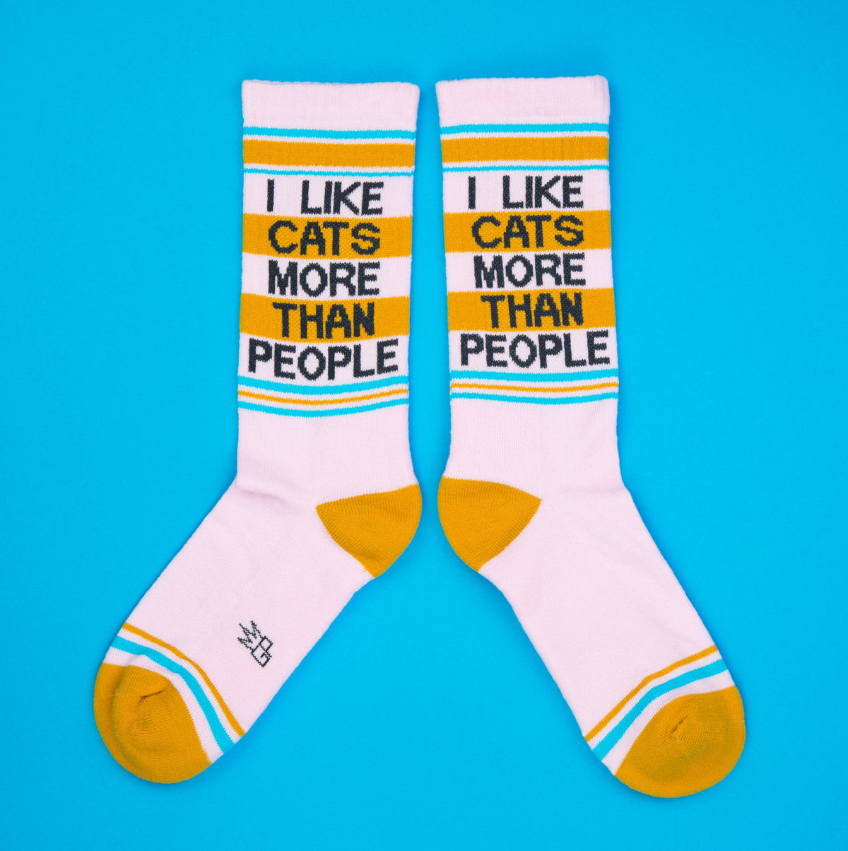 Pair of socks with 'I Like Cats More Than People' text on a blue background