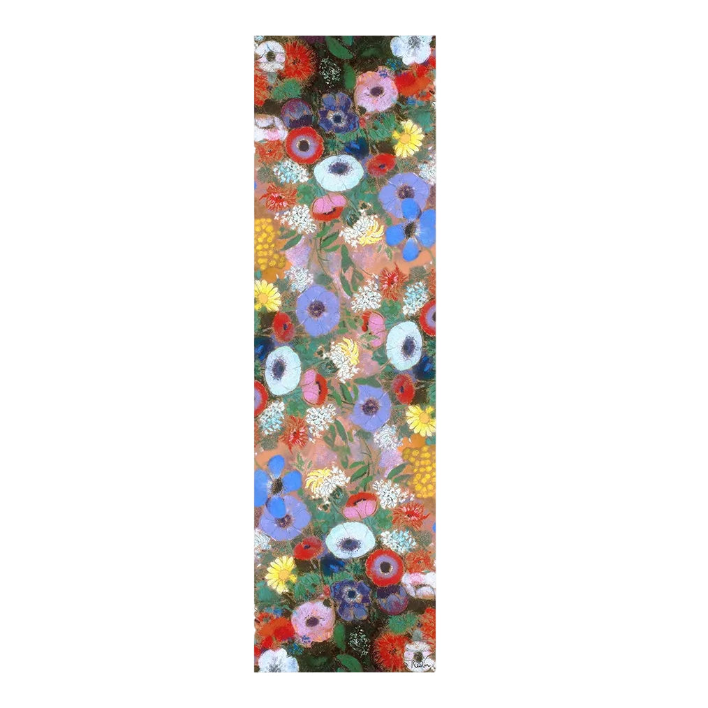 A tall, narrow rectangular scarf featuring a dense floral pattern with many colorful flowers on a dark background, centered on a light beige backdrop.